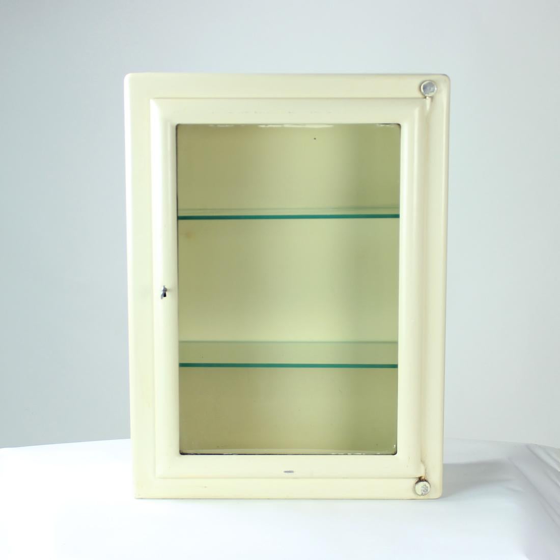 Beautiful vintage medical cabinet produced in Czechoslovakia in 1950s. Originally, the cabinet has been used in hospitals. The cabinet is wall-mounted piece with two brackets to hold the piece on the wall safely. The cabinet is made of steel with