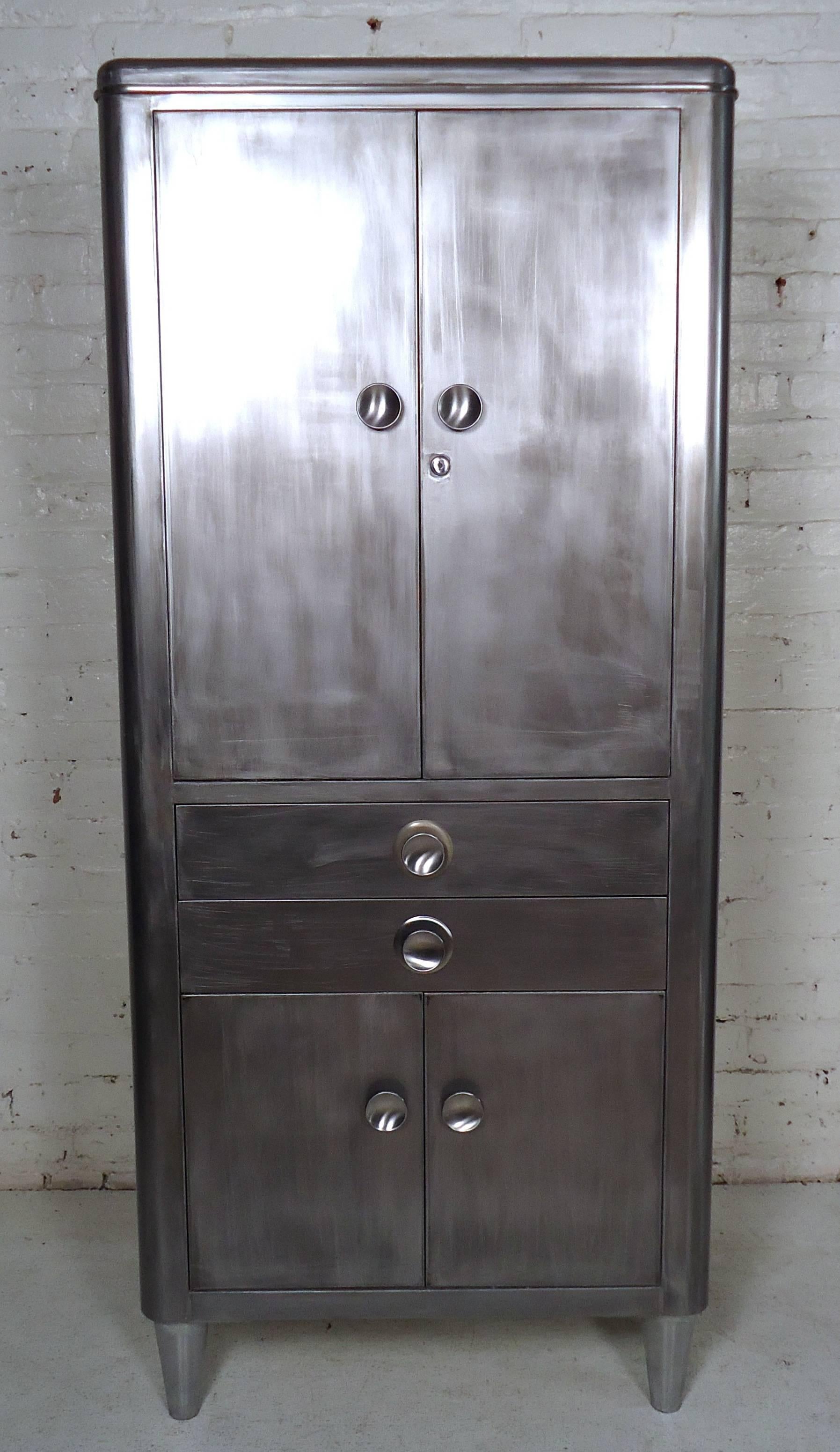 Heavy duty metal storage cabinet restored in a unique Industrial style finish. Top Compartment holds glass shelves, spacious bottom compartment, and two drawers.

(Please confirm item location - NY or NJ - with dealer).