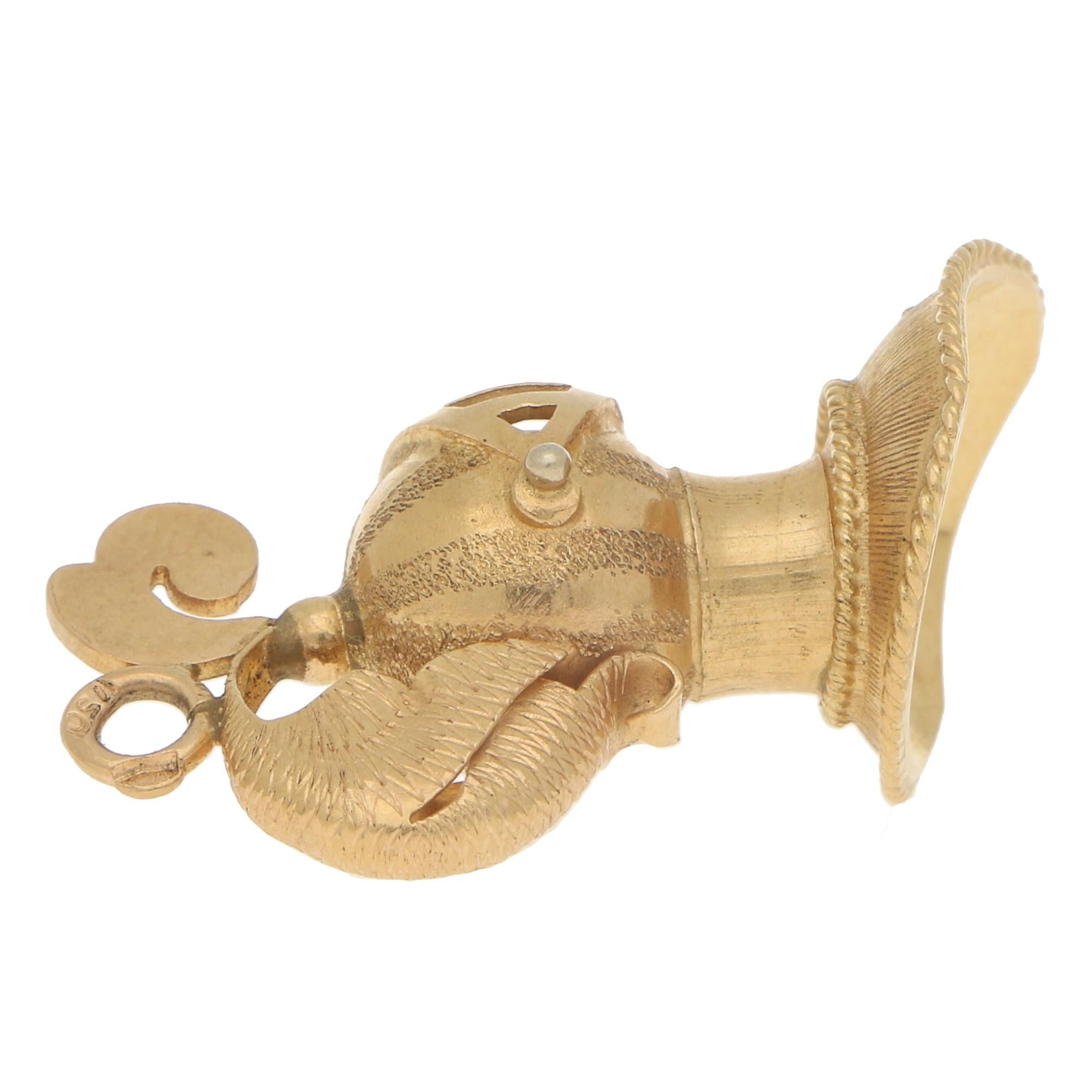 A rather interesting vintage knight helmet charm made of 18 karat yellow gold. 

This quirky piece is designed as a medieval knight's helmet and is beautifully detailed. From the feathering on the back of the helmet with the added Maltese cross on