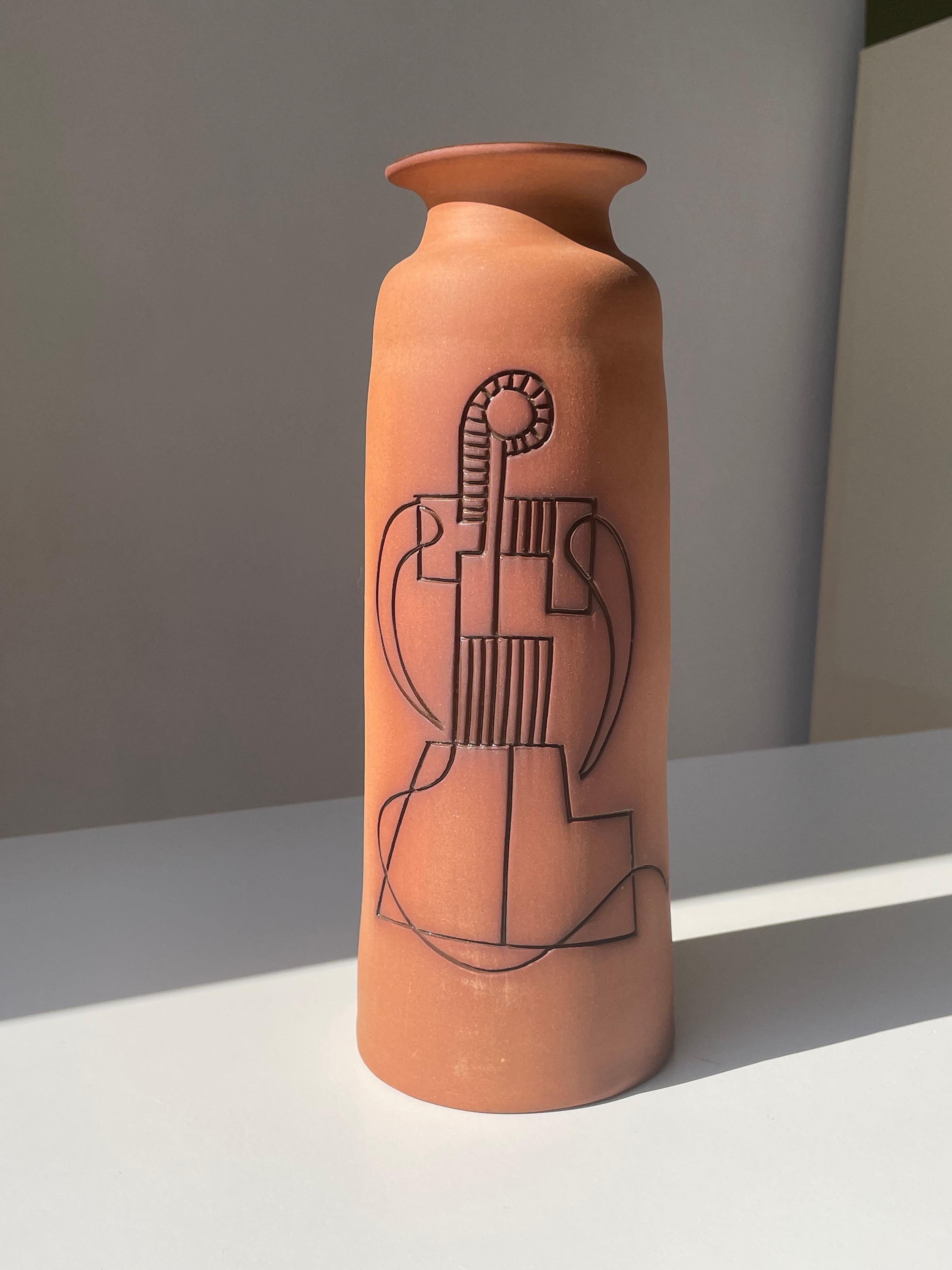 Tall contemporary minimalist ceramic vase handmade in Cyprus. Unglazed exterior with handcarved incised relief stylized organic decor with caramel brown glaze in the each graphic line. Shiny dark brown glaze on the inside. Signed under base.