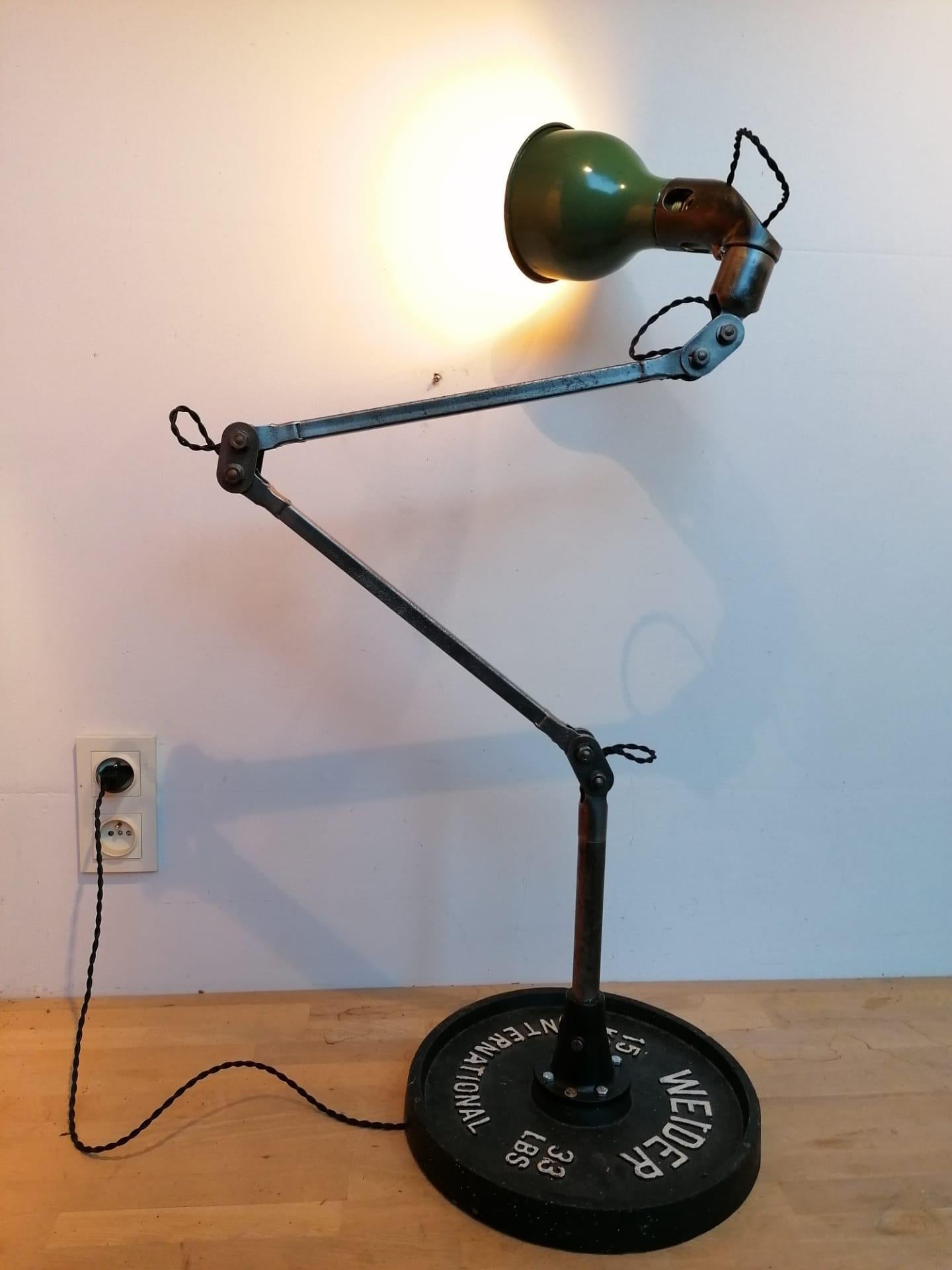 Stunning industrial machinist table or floor lamp manufactured by Mek Elek in the 1930s in London.

The lamp has interlocking joints and a articulated lamp shade making the lamp very adjustable and thus useful. 

A good amount of time has gone