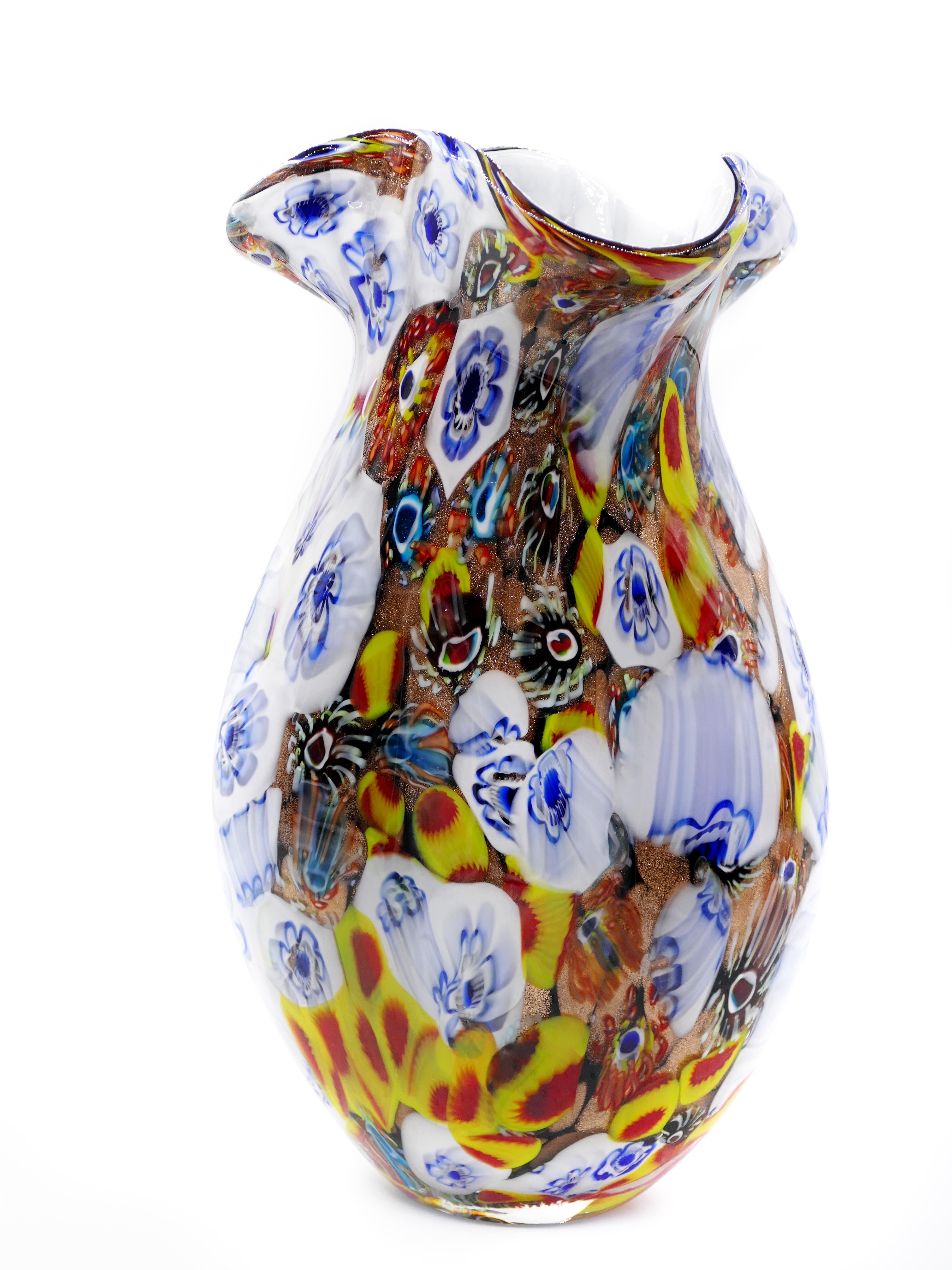 This is a melting glass vase, a wonderful decorative object with a particular surface (color melts and blue flowers) realized in 20th century, with an elegant sinuous design.

A colorful vase, in perfect conditions: as good as new, absolutely to