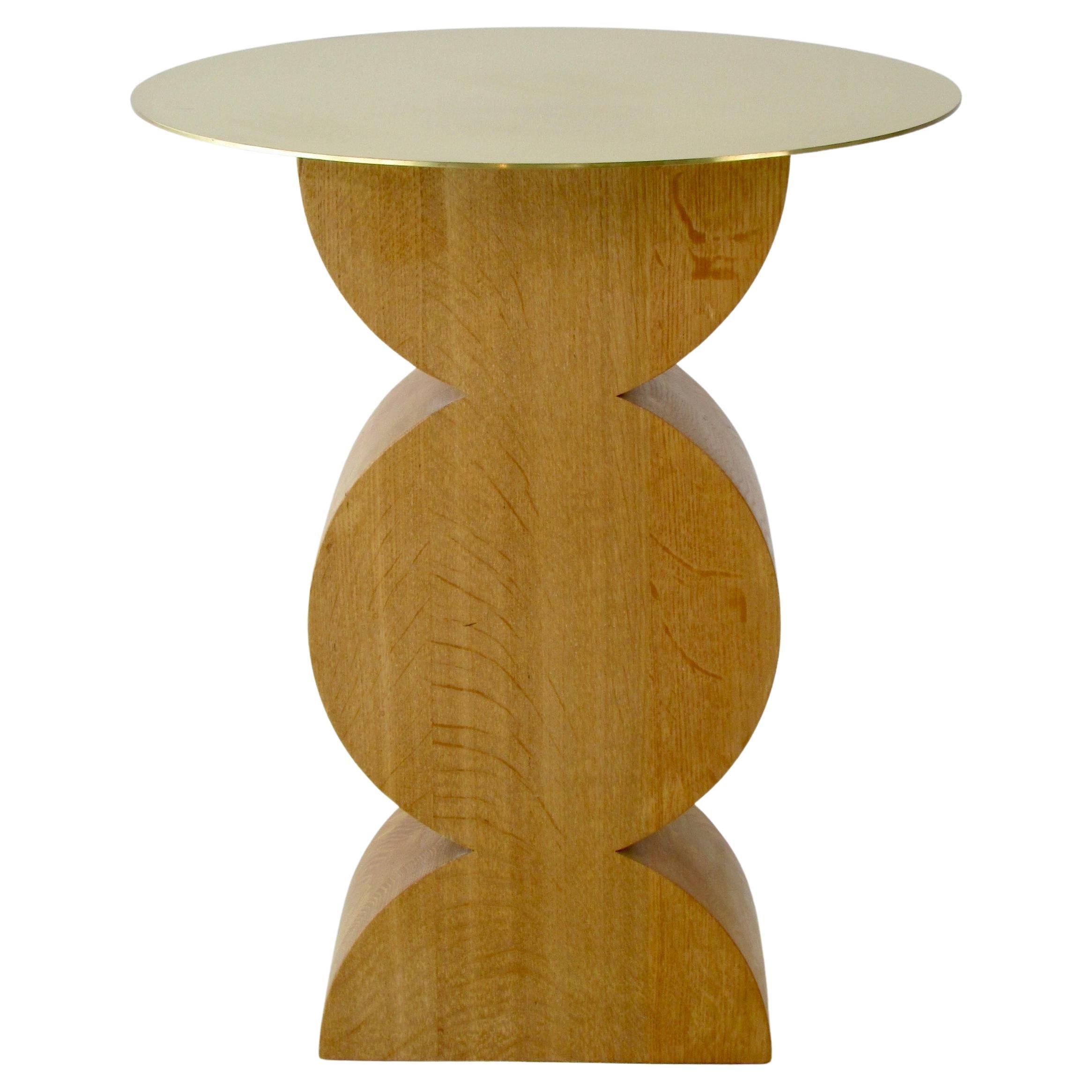 Studio Simon Constantin occasional table in oak wood with a polished brass top. The brass top appears to be floating on the thickset wood base. Italy, 1971 / 2013
Base measures 10.75w x 6.5d Italy 1971 / 2013
Table will be shipped with top removed.
