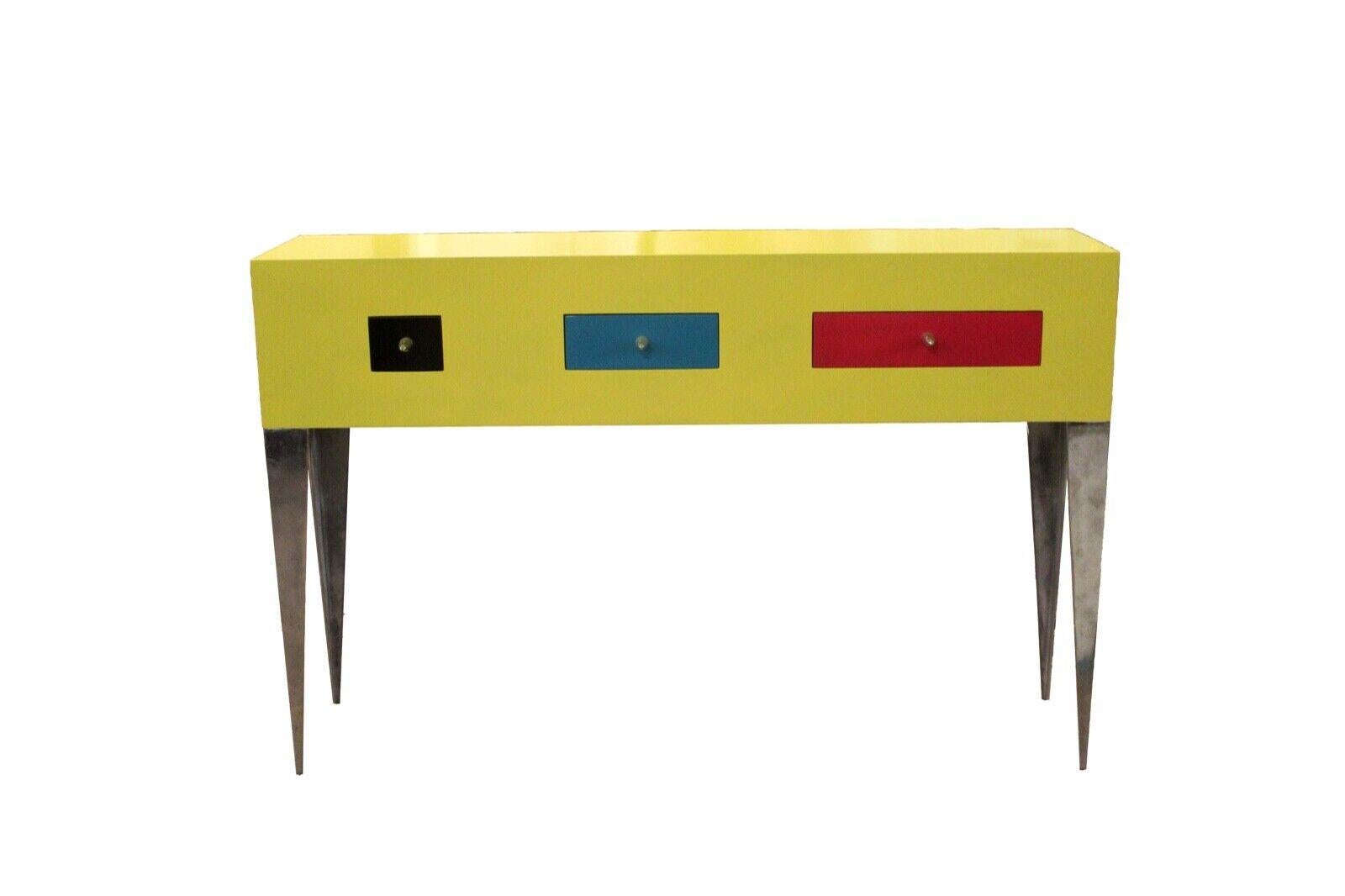 For your consideration is this funky Memphis Style yellow console table on brushed aluminum legs with three drawers painted black, blue, and red. Dimensions: 59