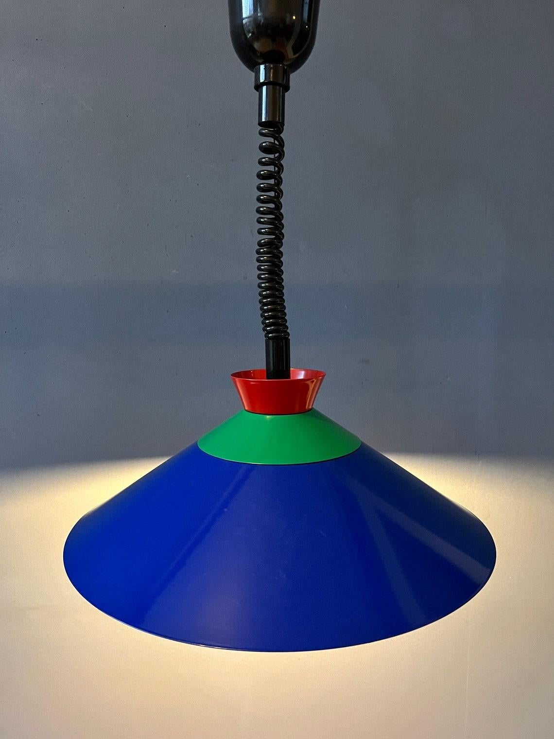 Vintage Memphis pendant in blue, green and red colour. The height of the lamp can easily be adjusted with the suspension mechanism. The lamp requires one E26/27 (standard) lightbulb.

Additional information:
Materials: Metal, plastic
Period:
