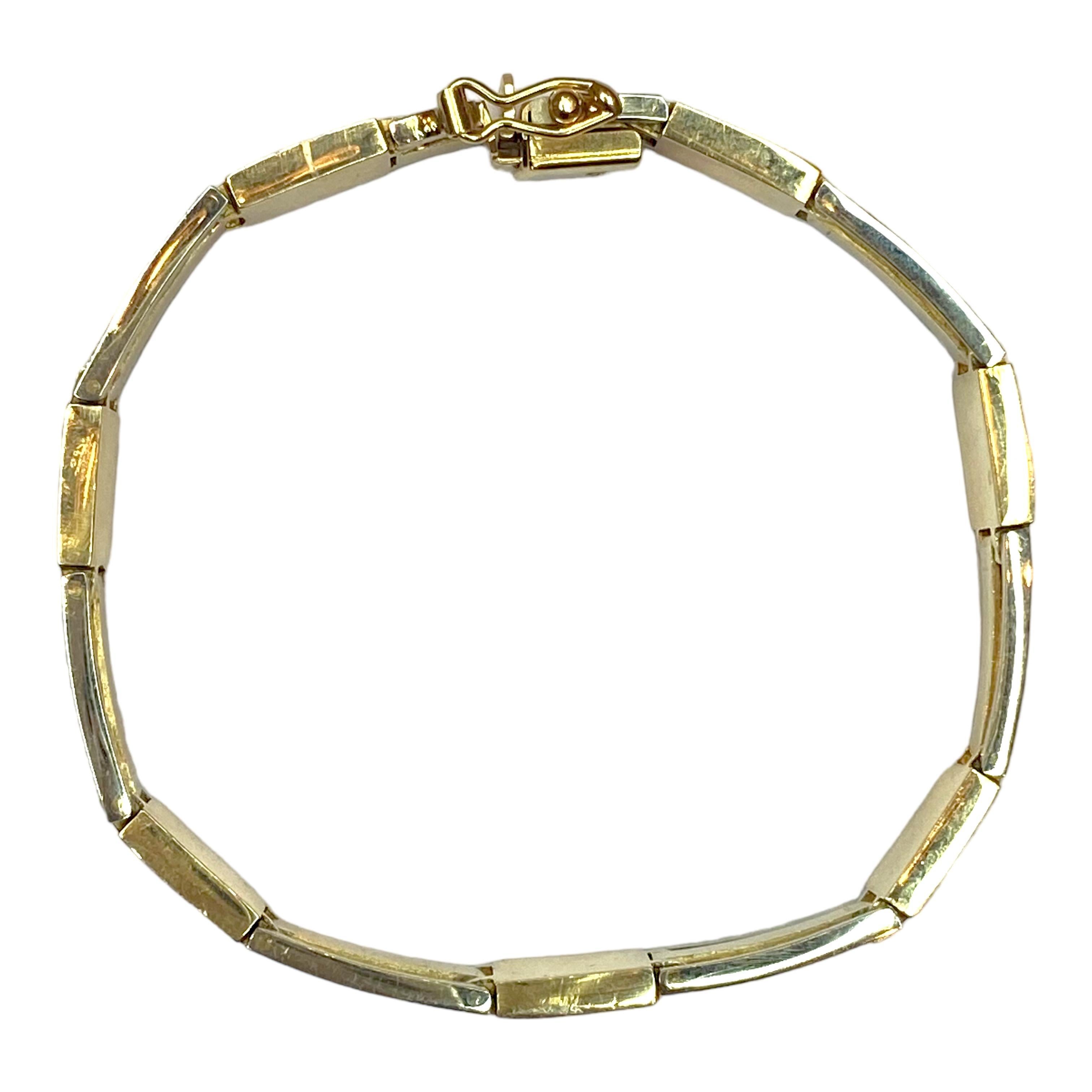 Crafted in 14K two tone bracelet, composed of seven black onyx sections alternating with white and yellow gold bar links. 
Bright polish and satin finish. Hidden box clasp with satey clasp.
Measurements:
Length: 8 inches
Width: 11 mm
Weight: 35.6