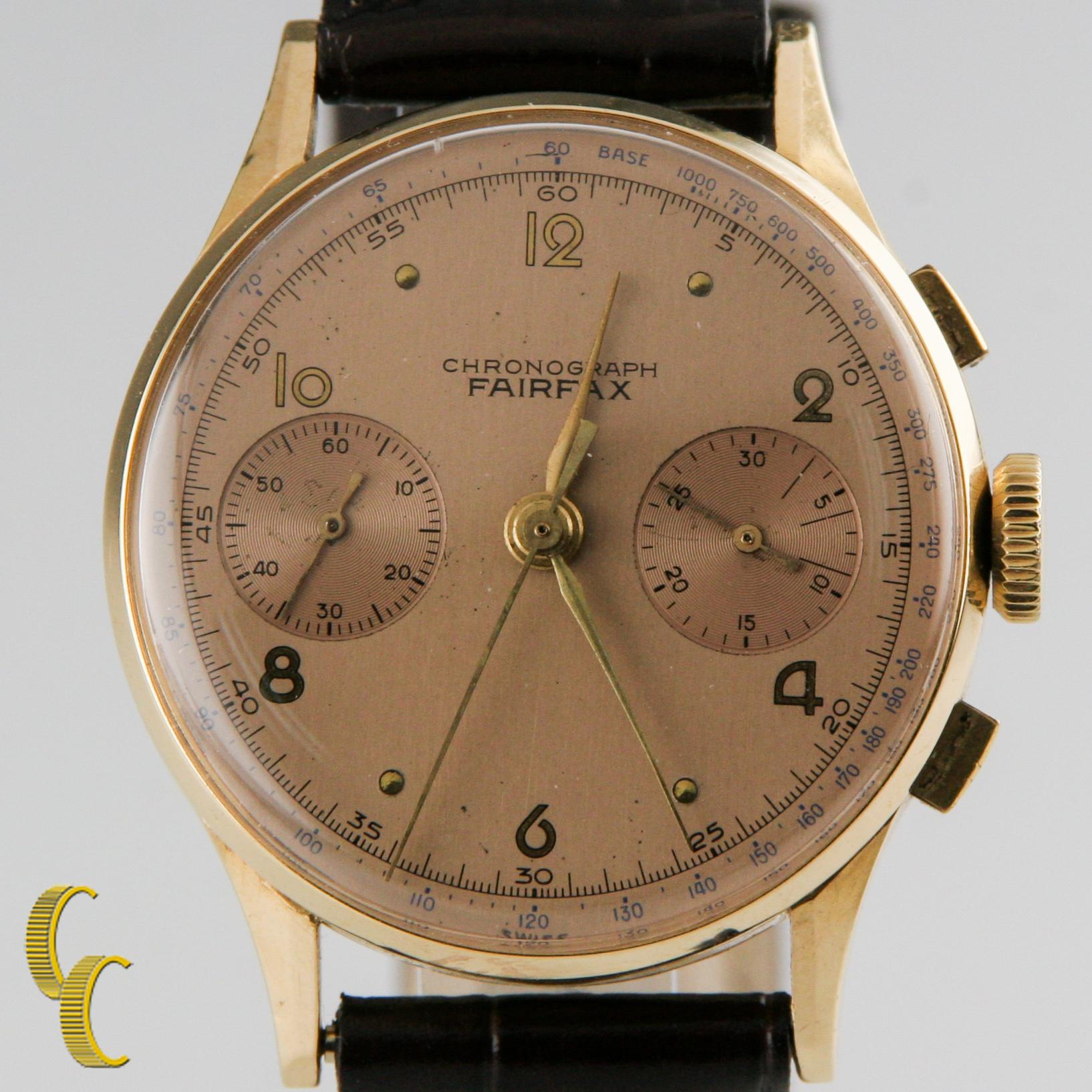 Vintage Men's Chronograph Fairfax 18K Yellow Gold Case w/Sub Dials & Tachymeter

Movement # 1414

Round 18k Yellow Gold Case
Width=33mm  (35 mm w/ Crown)
Lug-to-Lug Distance= 41 mm
Thickness = 7 mm

Light Rose Colored Dial w/Gold H + M + S