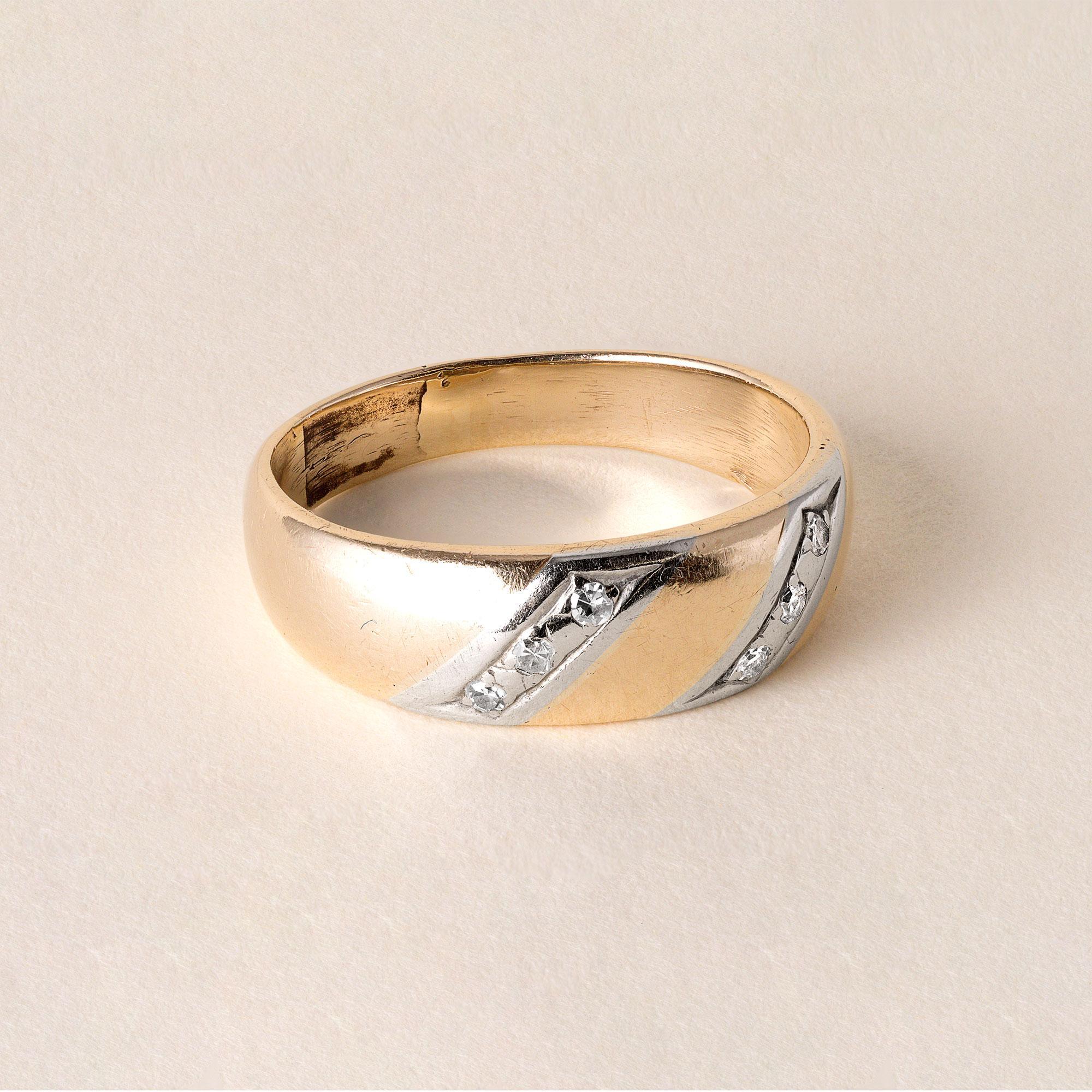 Vintage band circa 1950s
Six single cut diamonds inlaid in white gold diagonal stripes
diamond weight 0.05 carats
5.5 grams
F-G VS
Ring size 10.25
Band measures 7.2mm tapering down to 4.1mm
Stamped 14K in shank
Can be polished upon request