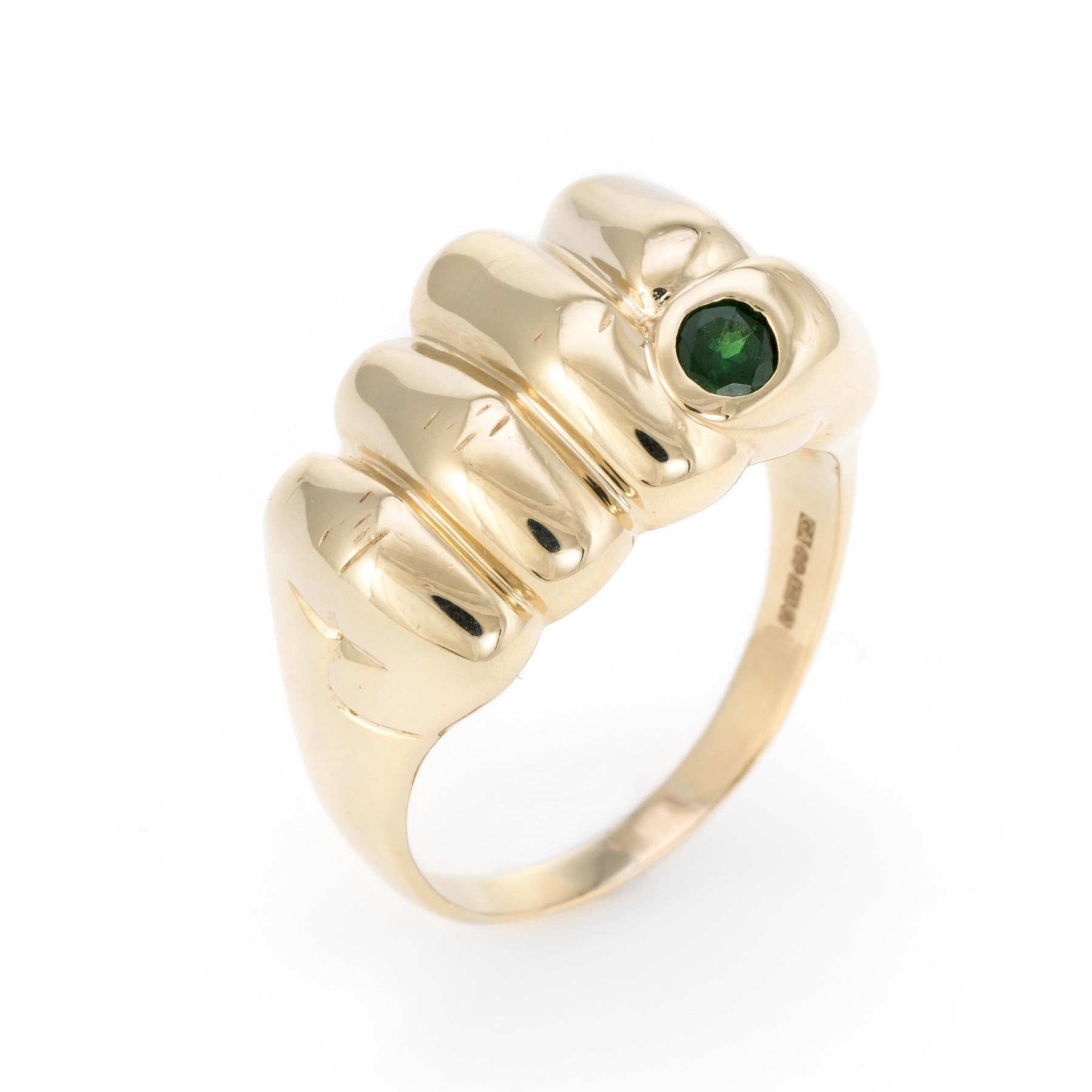 Distinct and unique vintage fist pump ring, crafted in 9 karat yellow gold. 

One estimated 0.20 carat green tourmaline is set into the band. The tourmaline is in excellent condition and free of cracks or chips.

The ring is in excellent condition