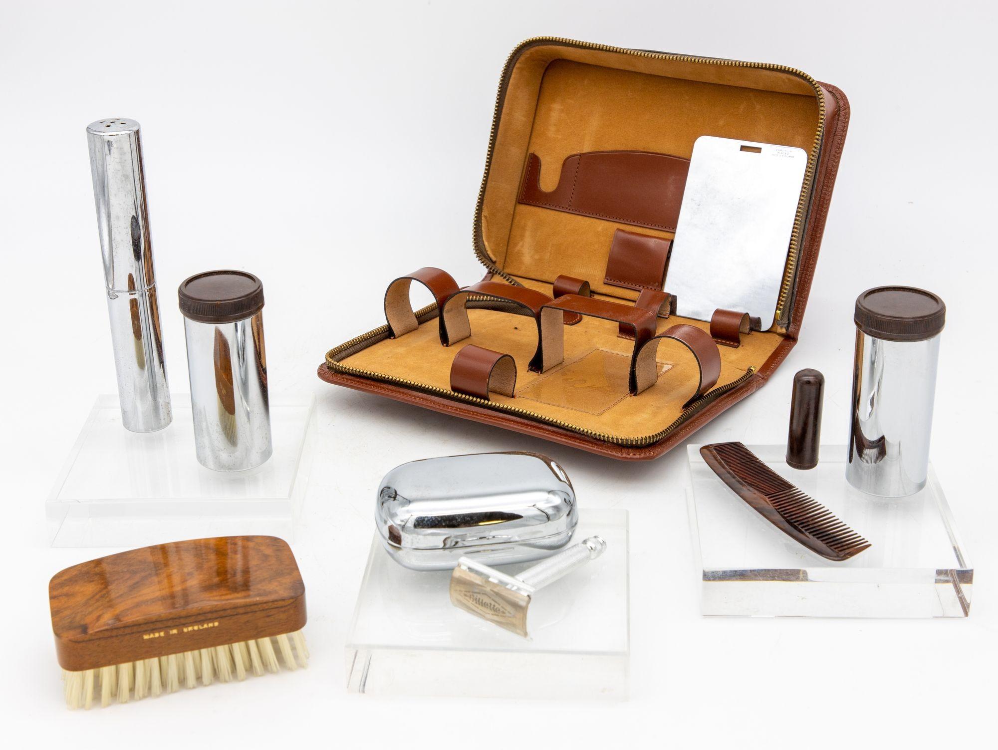 This refined mid-20th century English men's travel grooming kit is thoughtfly designed for the discerning gentleman on the go. This sophisticated set is housed in a high-quality leather case, featuring a sturdy zipper for secure storage and easy
