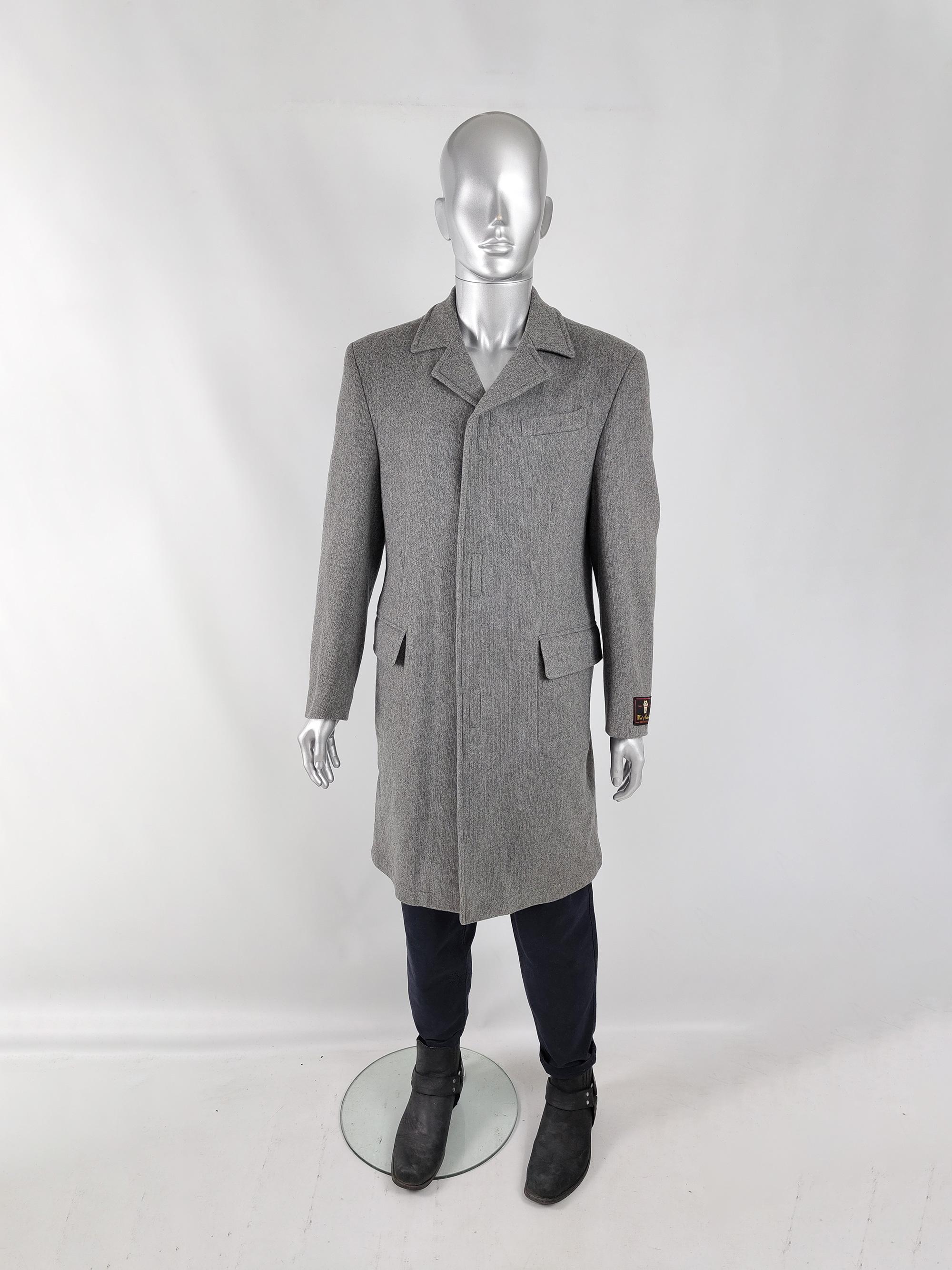 An excellent and stylish vintage mens Italian overcoat from the late 80s / early 90s by Battaglia. Made in Italy, from a grey wool and cashmere mix knit fabric with a long, sleek fit and hook and loop tape (velcro) fastenings at the front to give a
