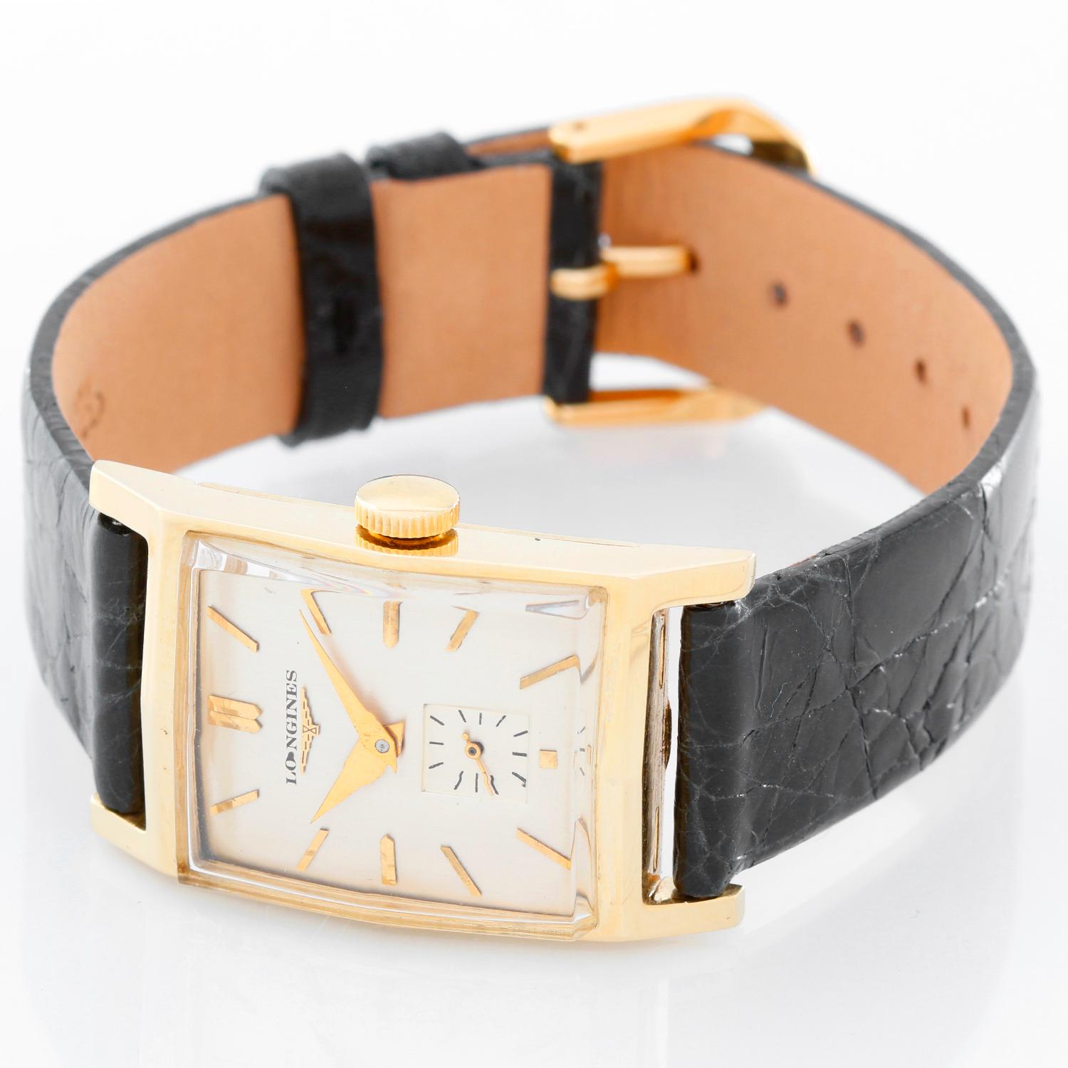 Vintage Men's/Ladies Longines 14K Yellow Gold Watch - Manual winding. 14K Yellow gold ( 22 mm x 37 mm ). Silver colored dial with gold stick hour markers. Black strap band with buckle. Pre-owned with custom box. Circa 1940's-50's.