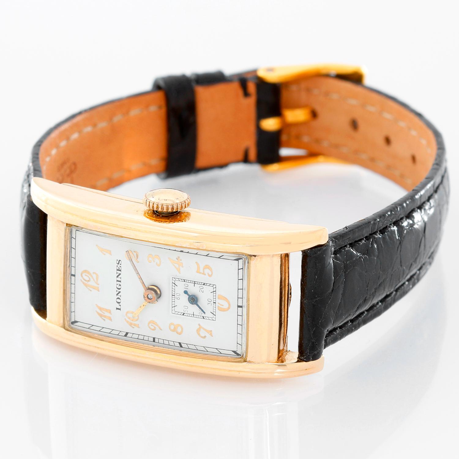 Vintage Men's Longines 14K Yellow Gold Watch - Manual winding. 14K Yellow gold ( 22 mm x 37 mm ). Silver colored dial with raised Breguet numbers . Black strap band with buckle. Pre-owned with custom box. 