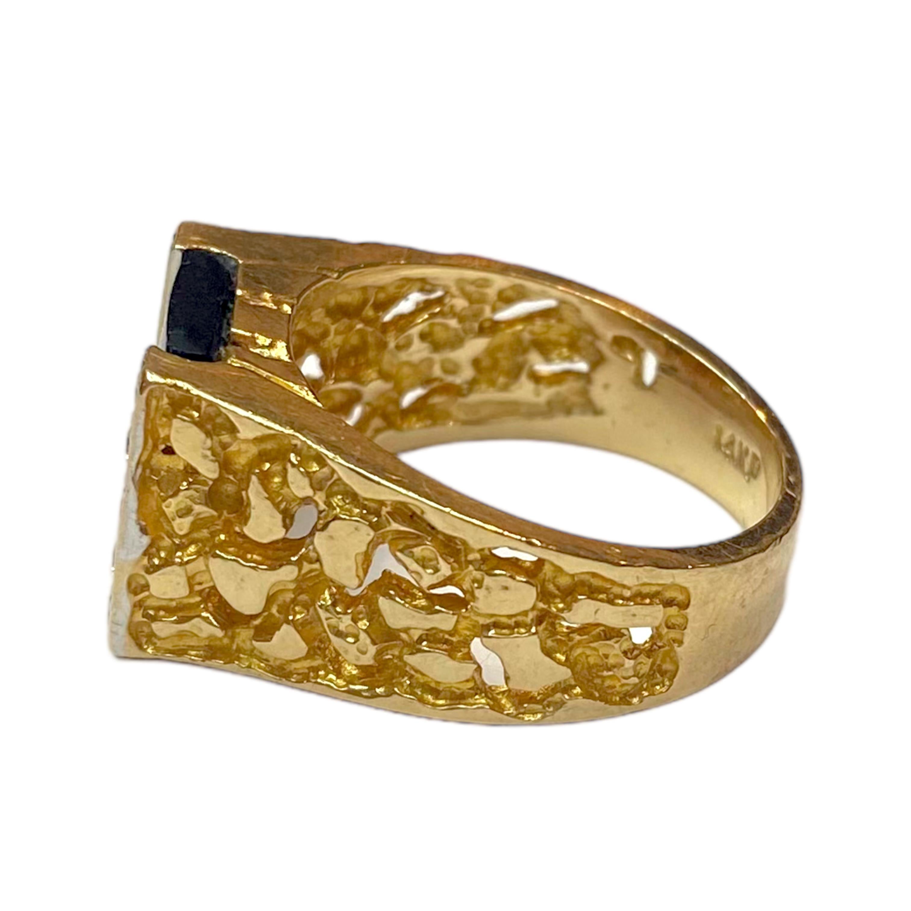 Crafted in 14K yellow gold, the ring features a rectangular black onyx on the front framed by diamonds, supported by thirteen millimeter wide shoulder tapering down to a five millimeter wide band.
10 round brilliant cut diamonds: 0.20ctw. Color: