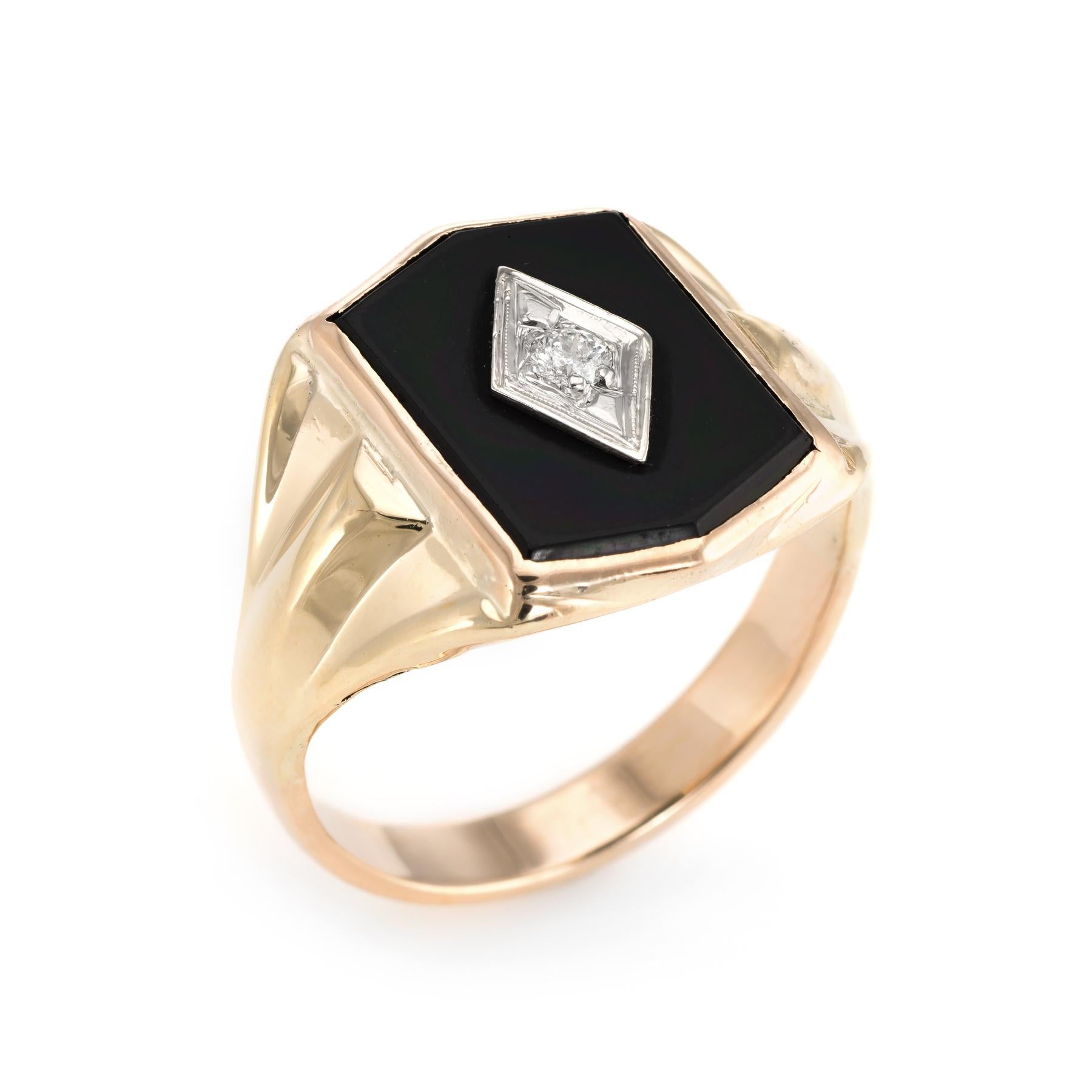 Finely detailed vintage men's cocktail ring (circa 1960s to 1970s), crafted in 14 karat yellow gold. 

Round brilliant cut diamond is estimated at 0.10 carats (estimated at H-I color and I1 clarity). The onyx measures 17mm x 12mm (in excellent