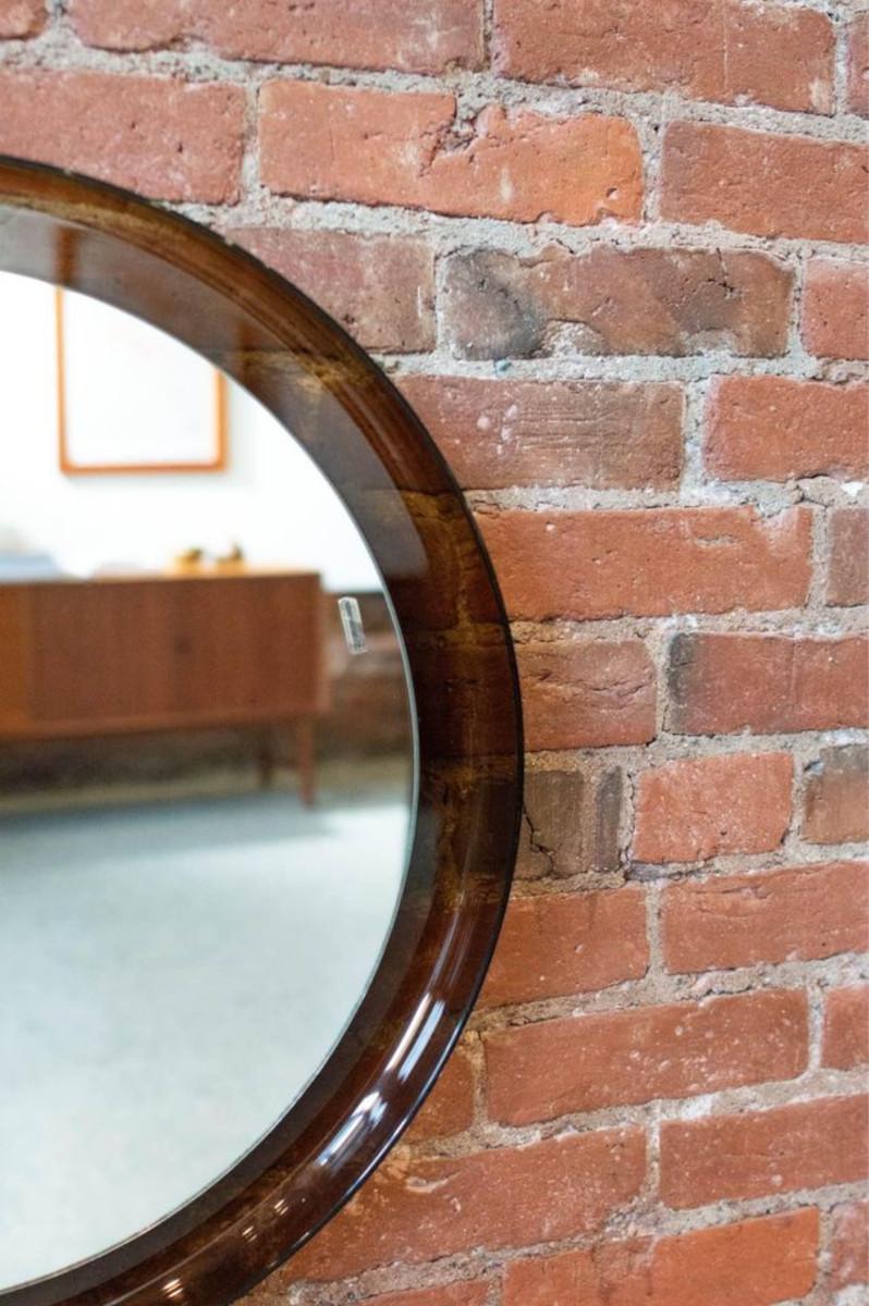 Dieser runde Acrylspiegel im Vintage-Stil von Merlo Guzzini ist ein zeitloses Stück, das den Charme der Jahrhundertmitte ausstrahlt. Dieser sorgfältig gefertigte Spiegel hat einen eleganten Acrylrahmen, der in jedem Raum einen Blickfang darstellt.