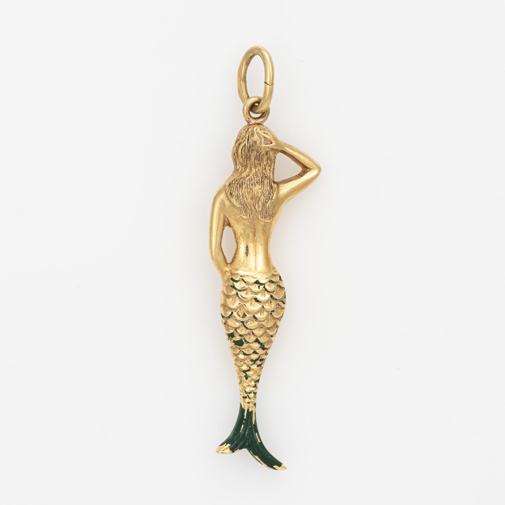 Finely detailed vintage Mermaid charm crafted in 14k yellow gold.  

The poised Mermaid with hand in hair and a green enameled tail makes a nice statement. The enchanting creature of mythology is thought to symbolize freedom and transformation.