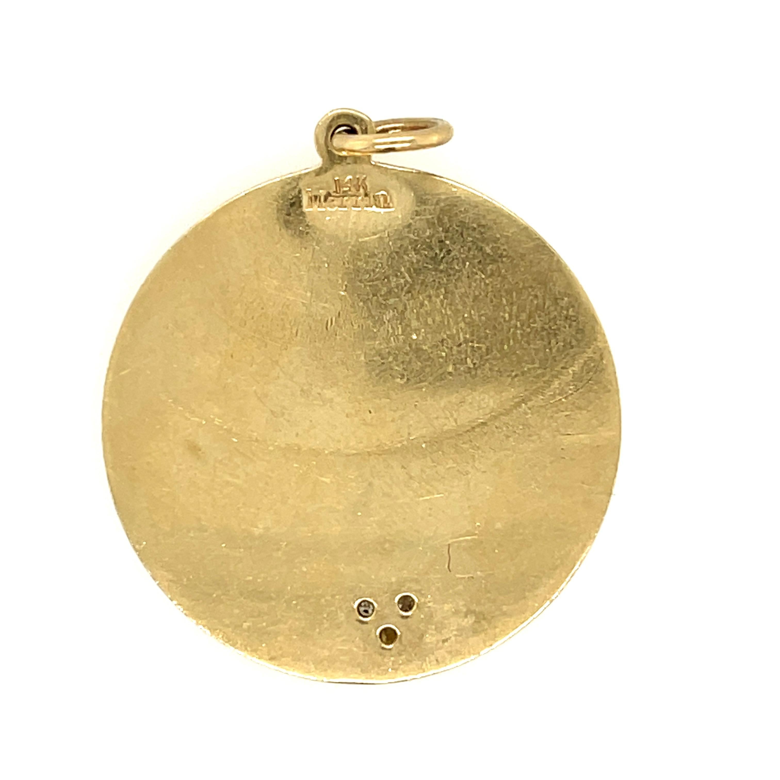 A 14 karat yellow gold love charm pendant with the poem spelling out 