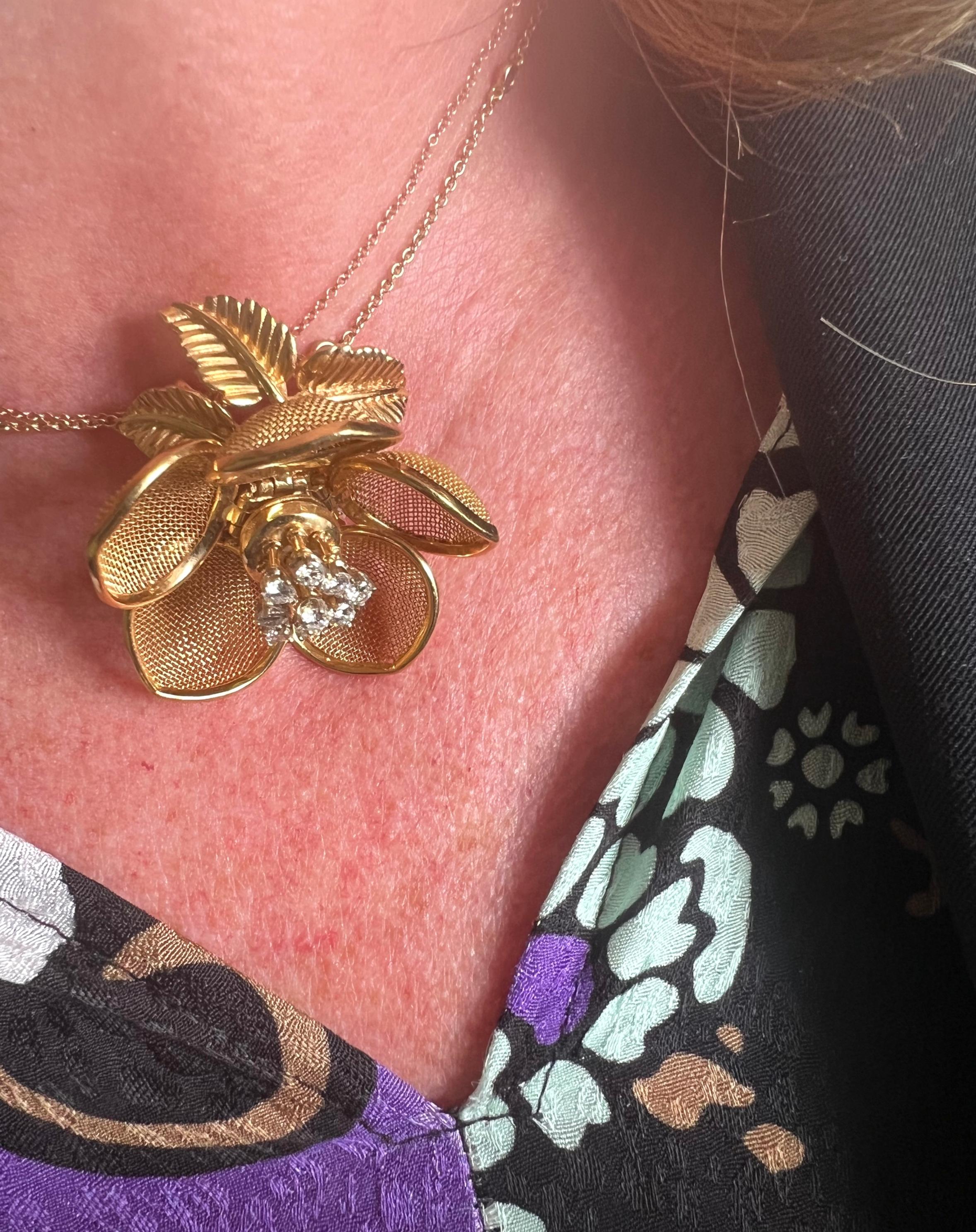 A vintage Merrin French diamond and gold mesh pendant, designed with articulated, gold edged, gold mesh opening and closing petals, surrounding trembling stamens, set with round brilliant-cut diamonds, in four claw settings, onto gold sepals and