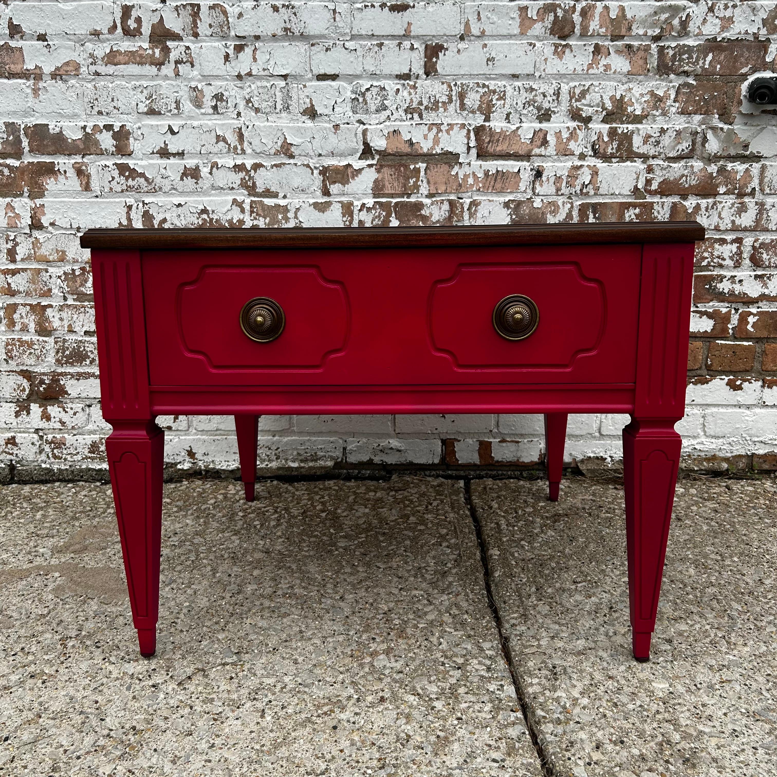 Fabulously pink -- this vintage side table by Mersman has never been more daring. We love the Art Deco carvings paired with the saturated fuchsia hue. A mesmerizing wood grain and pretty brass drawer pulls elevate the piece. The solid wood structure