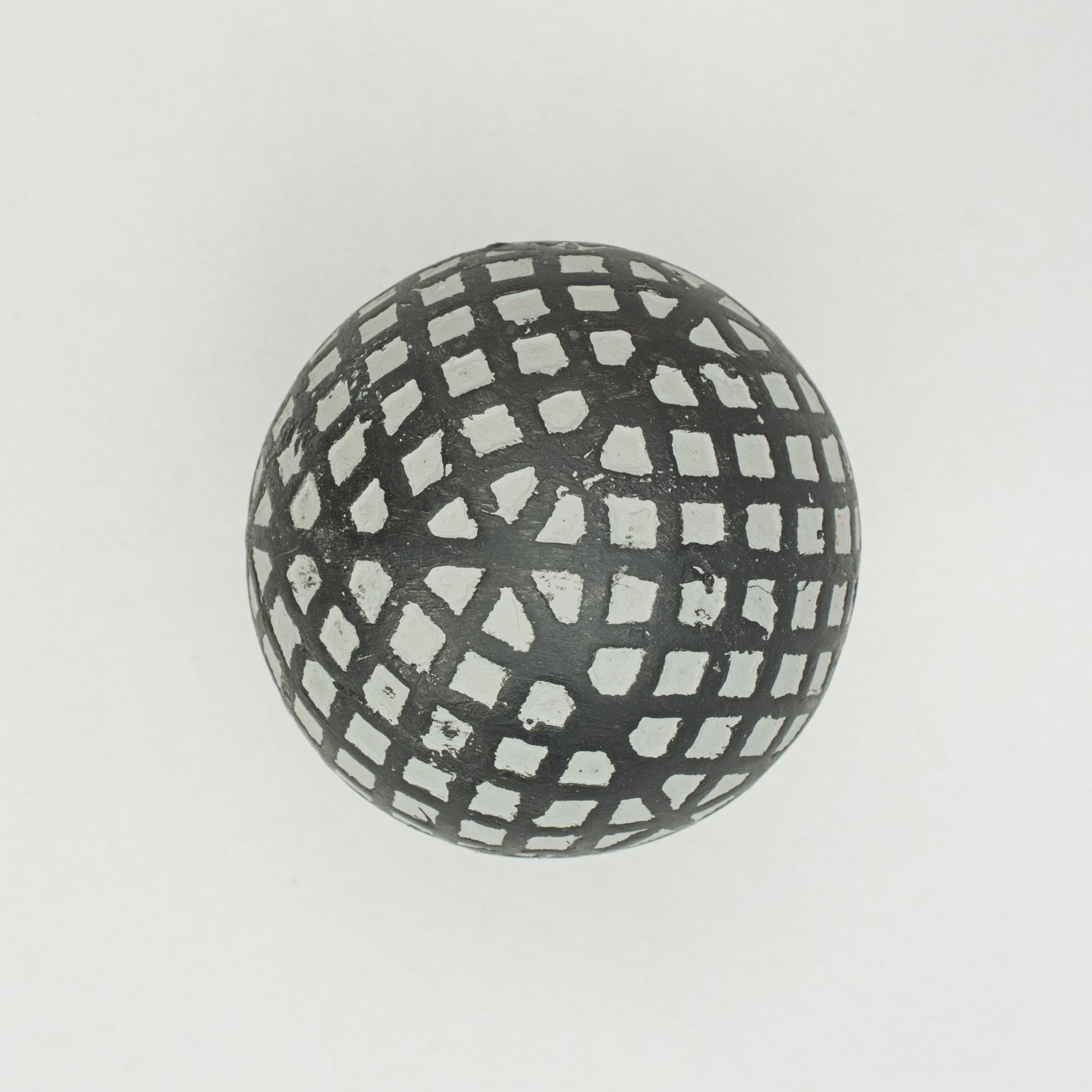 Mesh Pattern Maltese Cross Golf Ball.
A rubber core mesh golf ball in a refurbished condition. The ball has an unusual diamond mesh pattern with a 'Maltese Cross' on both poles of the ball, manufactured by Leyland and Birmingham Rubber Co.

The