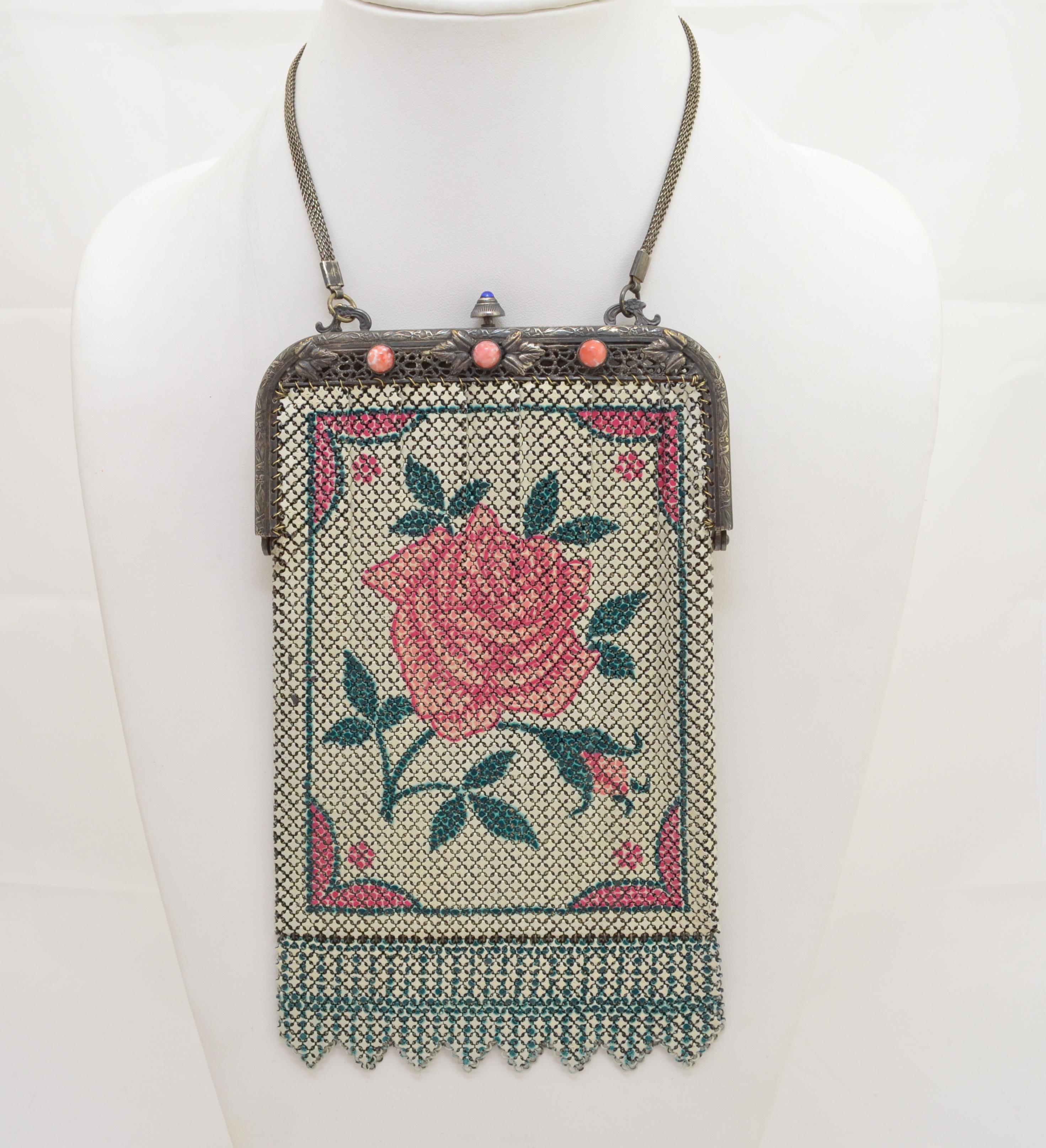 Vintage mesh bag features a rose print on silver-tone Metal with a sapphire button top push lock closure and chain handle. Bag has “Elsah” marked on the opening. 