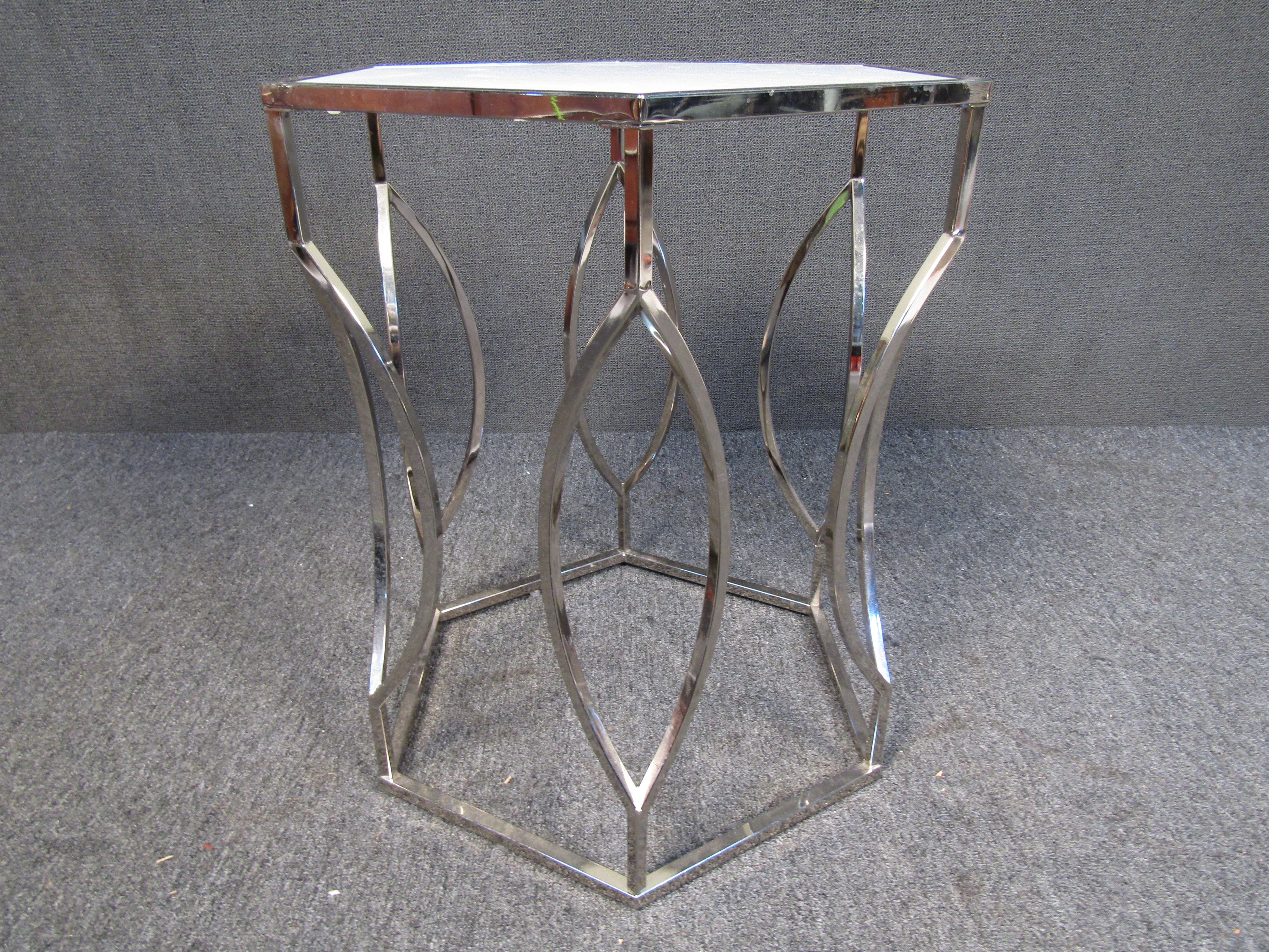 This Mid-Century Modern side table features a unique metal base forming a twisted design. The tables top is a detachable octagonal piece of milk glass. This table is sure to compliment any modern living space. Please confirm item location (NJ or NY).