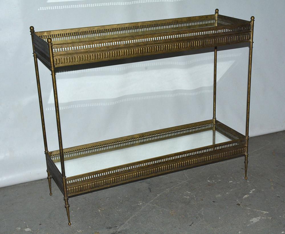 The vintage Regency style console have two mirrored gallery tray siding. The mottled metal 