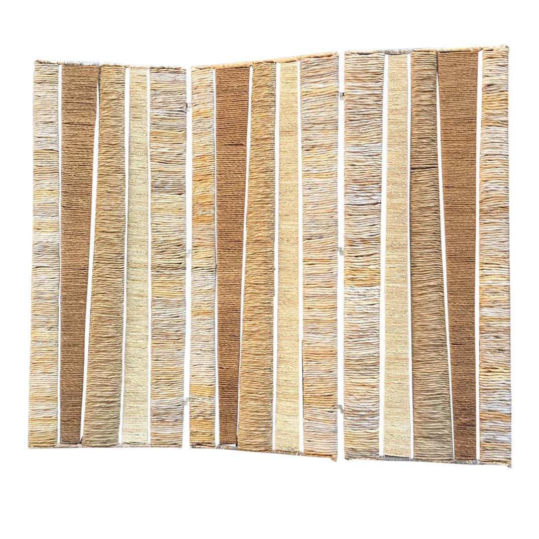 This abstract design folding screen consists of 3 folds, each fold features enameled metal big frame with smaller frames inside - rope, wicker and straw on them. There small black plastic legs. It is very heavy and stable.

This room divider has