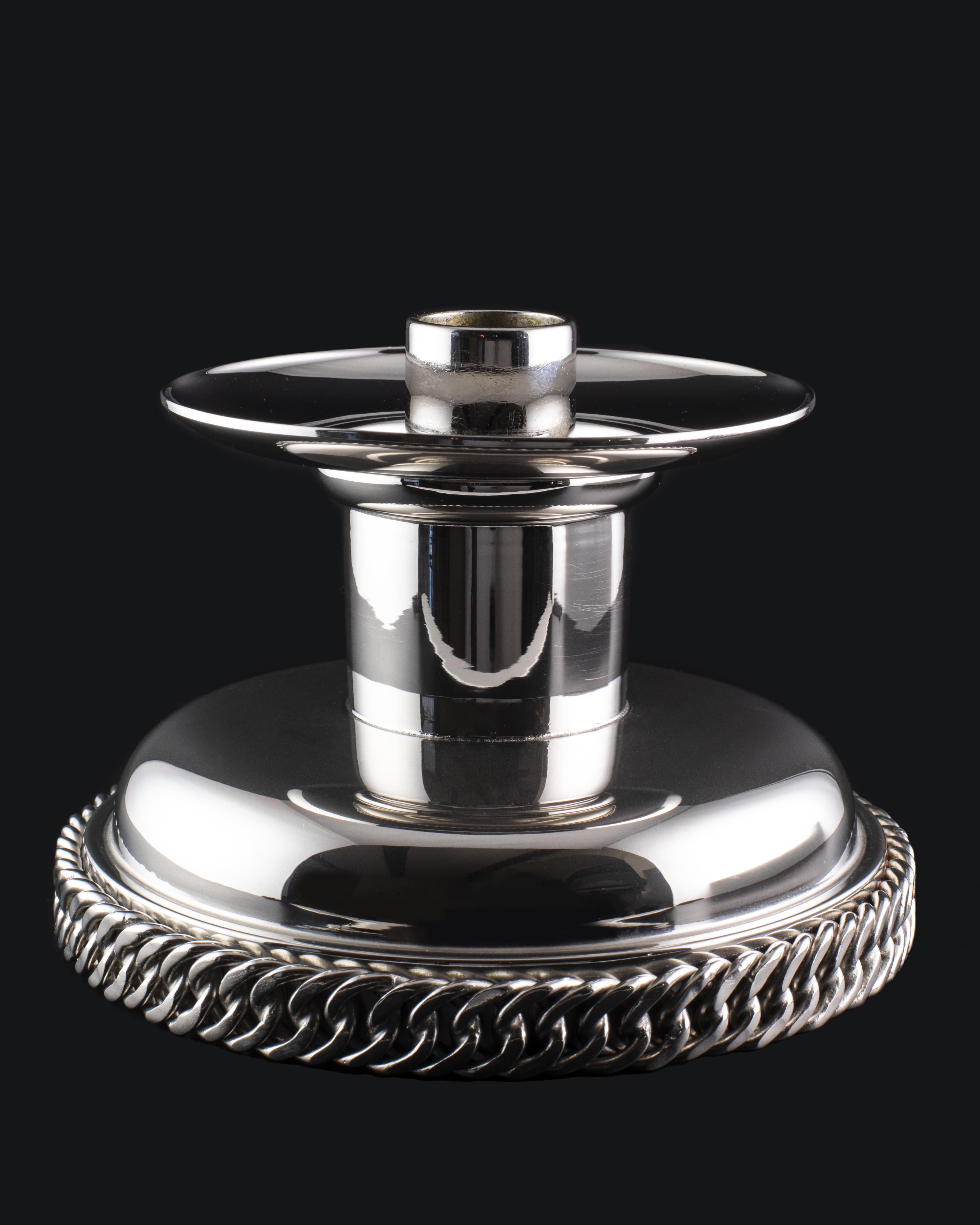 Stunning candlestick from Hermès Paris made in Metal argenté. The holder is simply beautiful with its discreet elegance and design. Embellished with the iconic Hermès chain that gives a touch of contemporary look. The candlestick is clearly marked