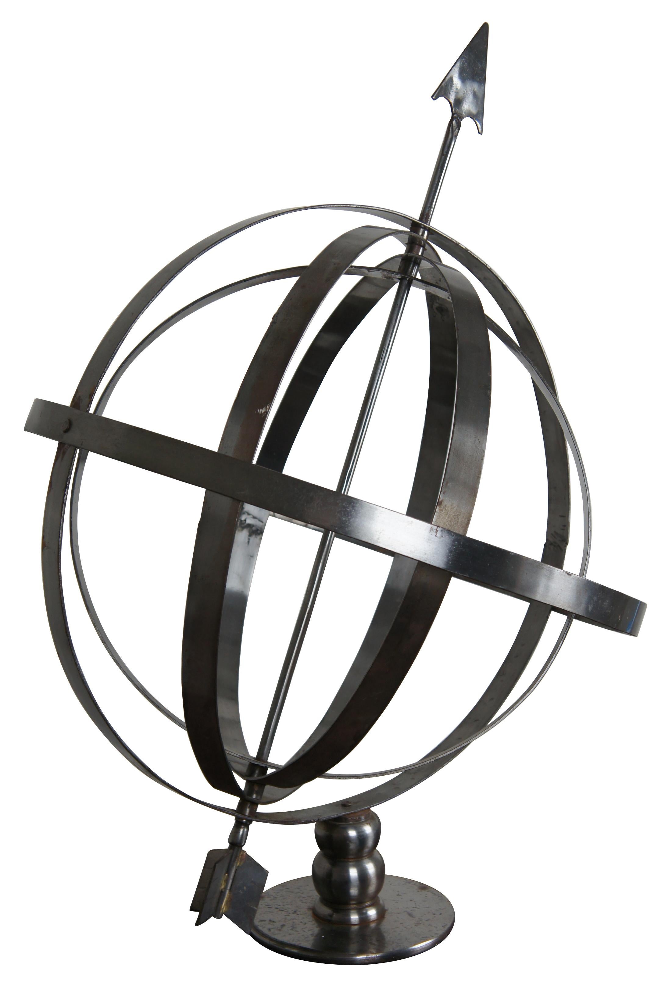 Vintage silver tone metal armillary sphere made of five concentric bands with an arrow through the axis. Measure: 34