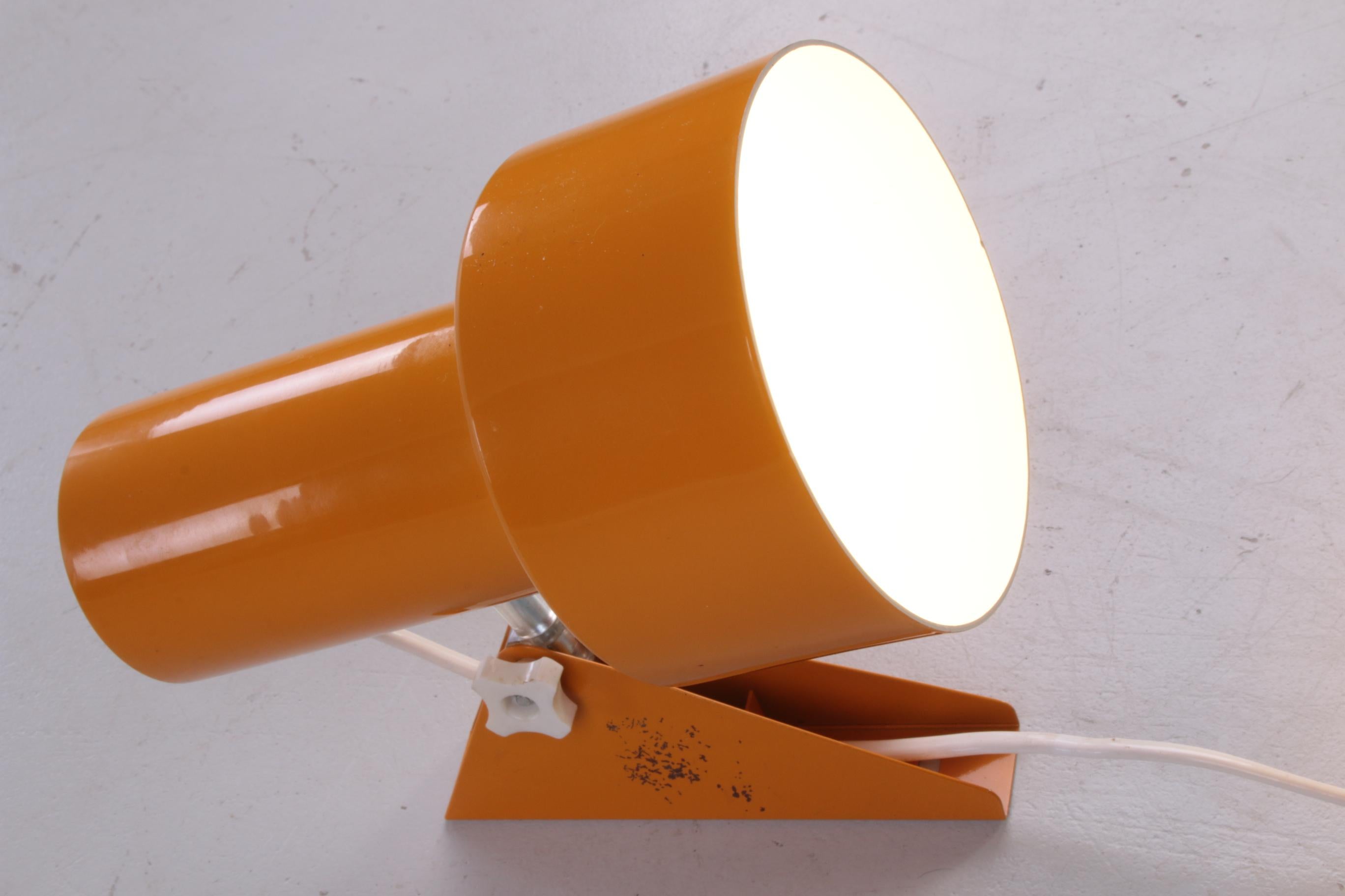 This beautiful ocher yellow spot comes from Denmark and was produced in the 1960s.

This spot is easily adjustable and can therefore be used to illuminate a beautiful wall decoration or of course as a reading light / night light.

The lamp has a