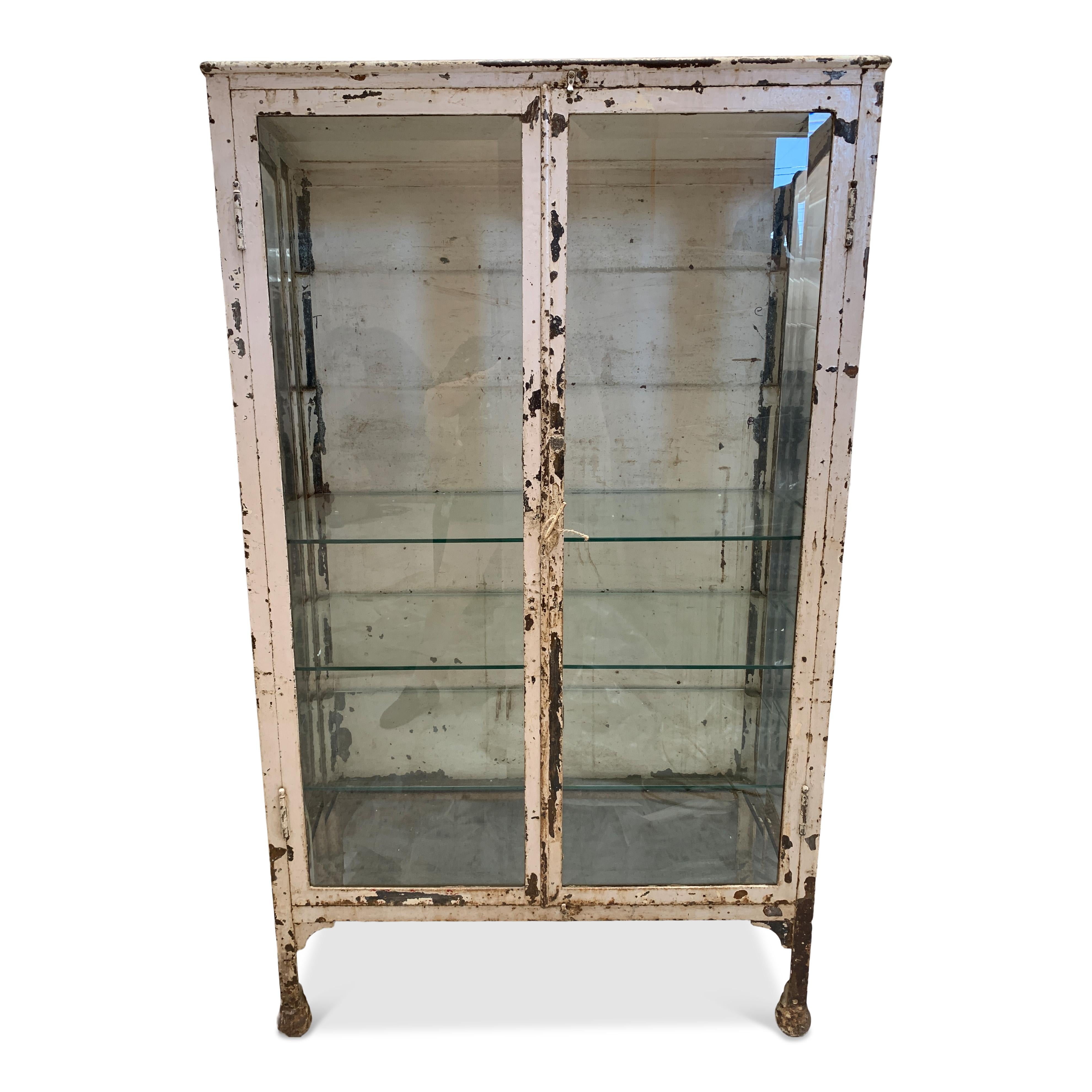 A stunning vintage piece will beautiful detailing that has only gotten better with age. The rustic wear of this cabinet gives it a beautiful vintage look while still being in wonderful working condition. This piece still has all of its original