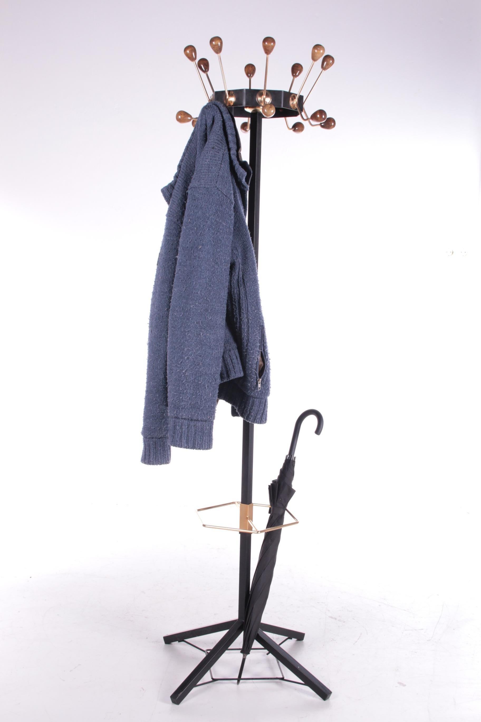Vintage Metal freestanding coat rack from France


This is a beautiful black metal coat rack, with a rotating top.

The knobs are made of wood and lacquered beautifully.

At the bottom is a gold-coloured brass ring for the umbrellas or