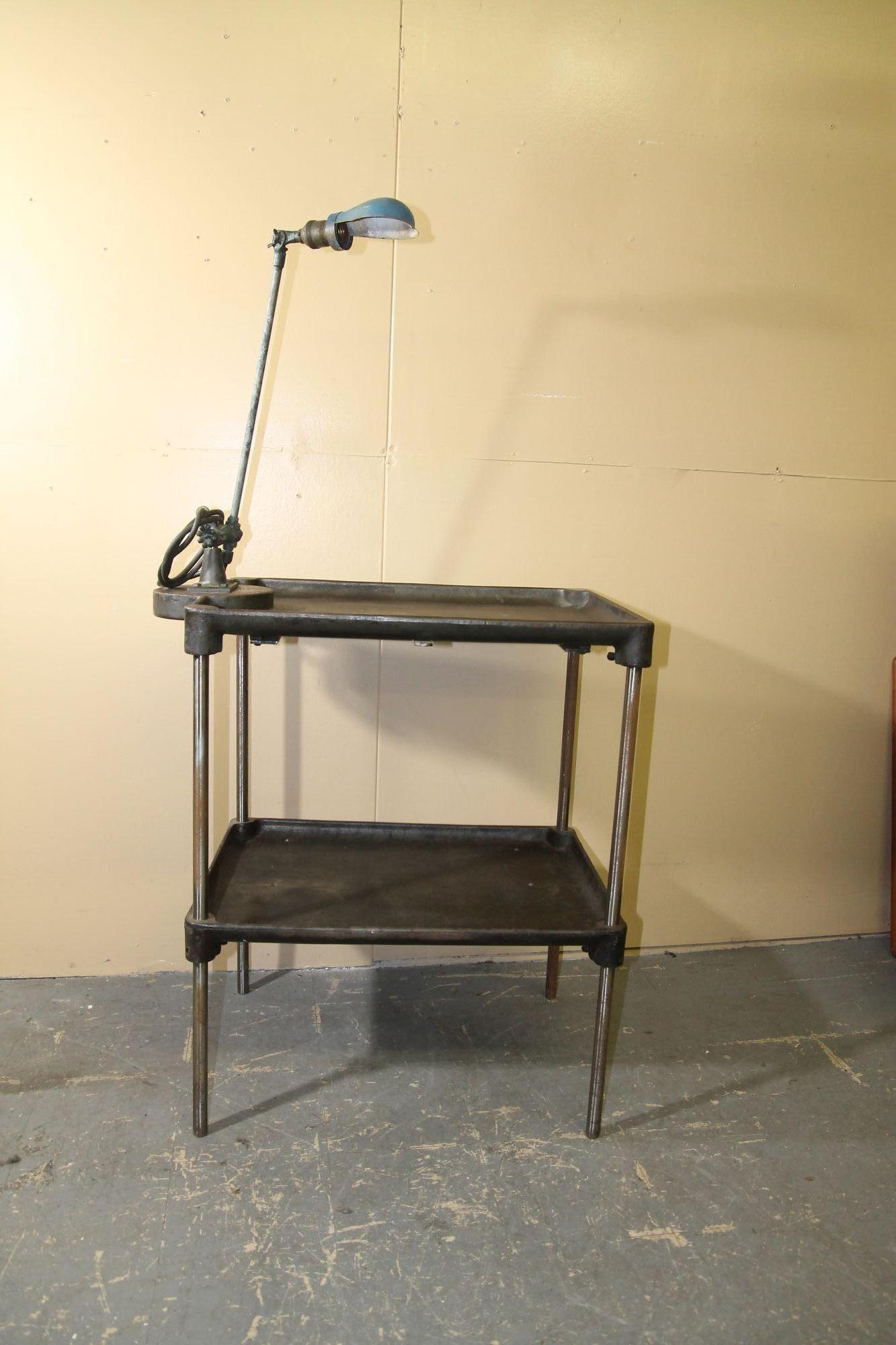 Ich freue mich, diesen großartigen Metall-Arbeitstisch mit einer OC White Arbeitsleuchte anbieten zu können, die daran befestigt ist. Diese über 100 Jahre alten Tische stammen aus einer Schraubenfabrik in Ohio. Dies ist ein schöner Beistelltisch