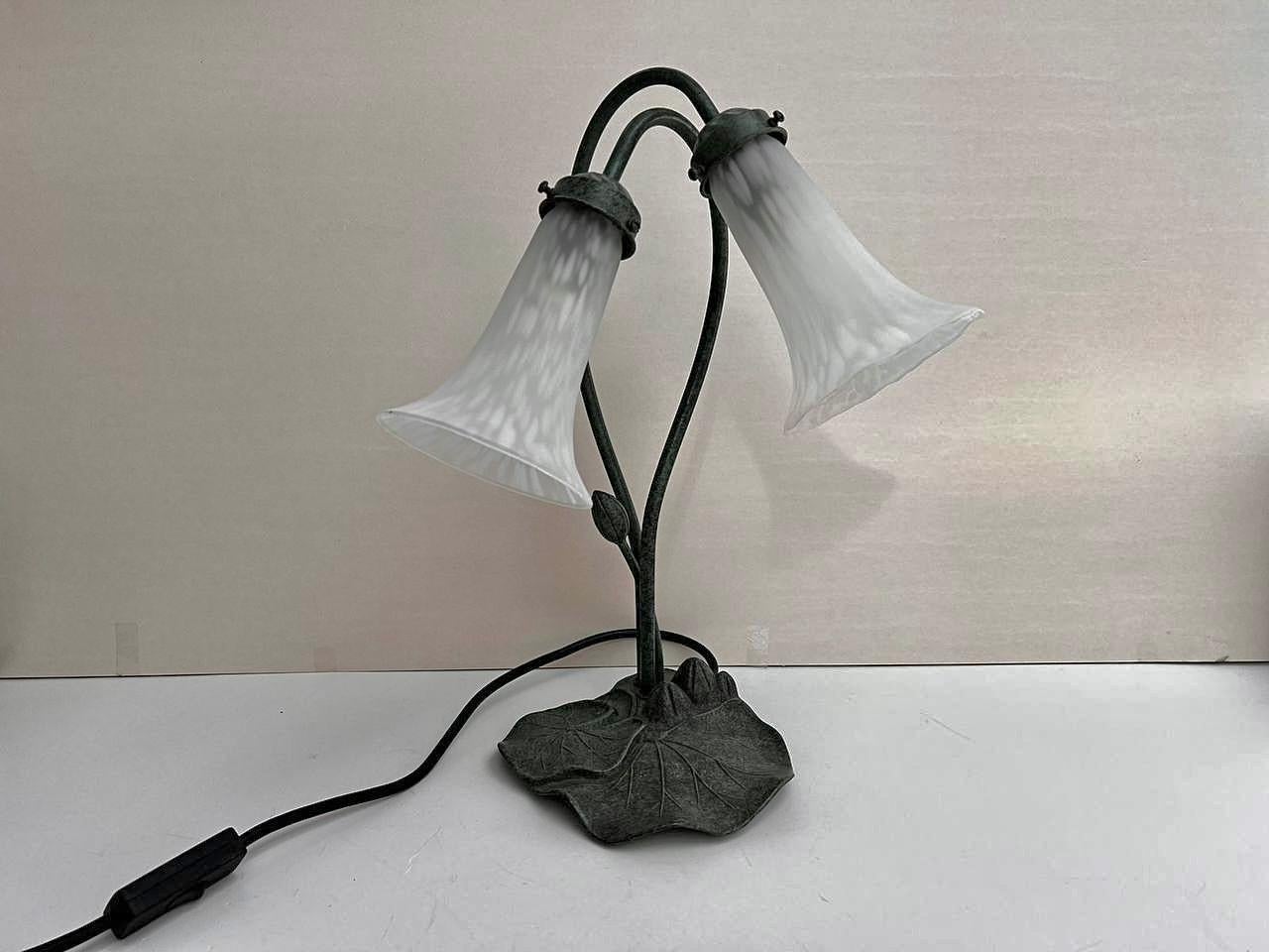 Charming water lily lamp with a lily pad base and white fluted lily flower shades. Belgium, 1990s

A quality reproduction of an Art Nouveau style lamp.

Metal table lamp with reliefs in the form of water lily leaves, 2 plafonds in the form of