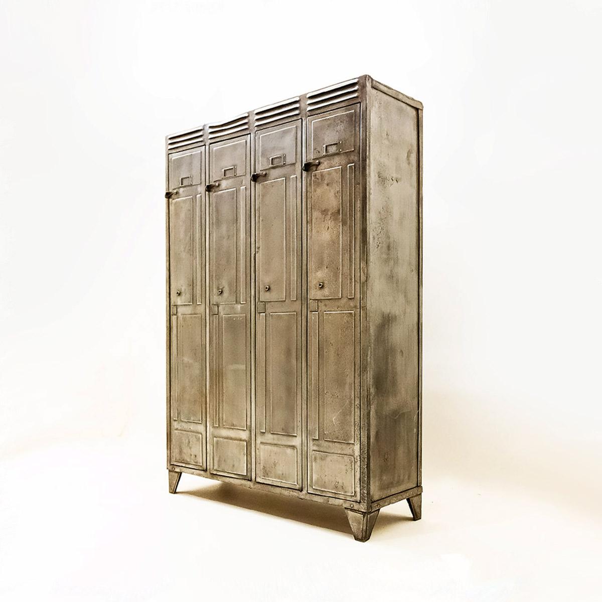 Vintage 1930s metal locker unit with 4 sections in a distressed bare metal finish. 

Believed to be French or German and dating from the 1930s this is a classic industrial set of 4 separate locker sections configured into a single unit. Each locker