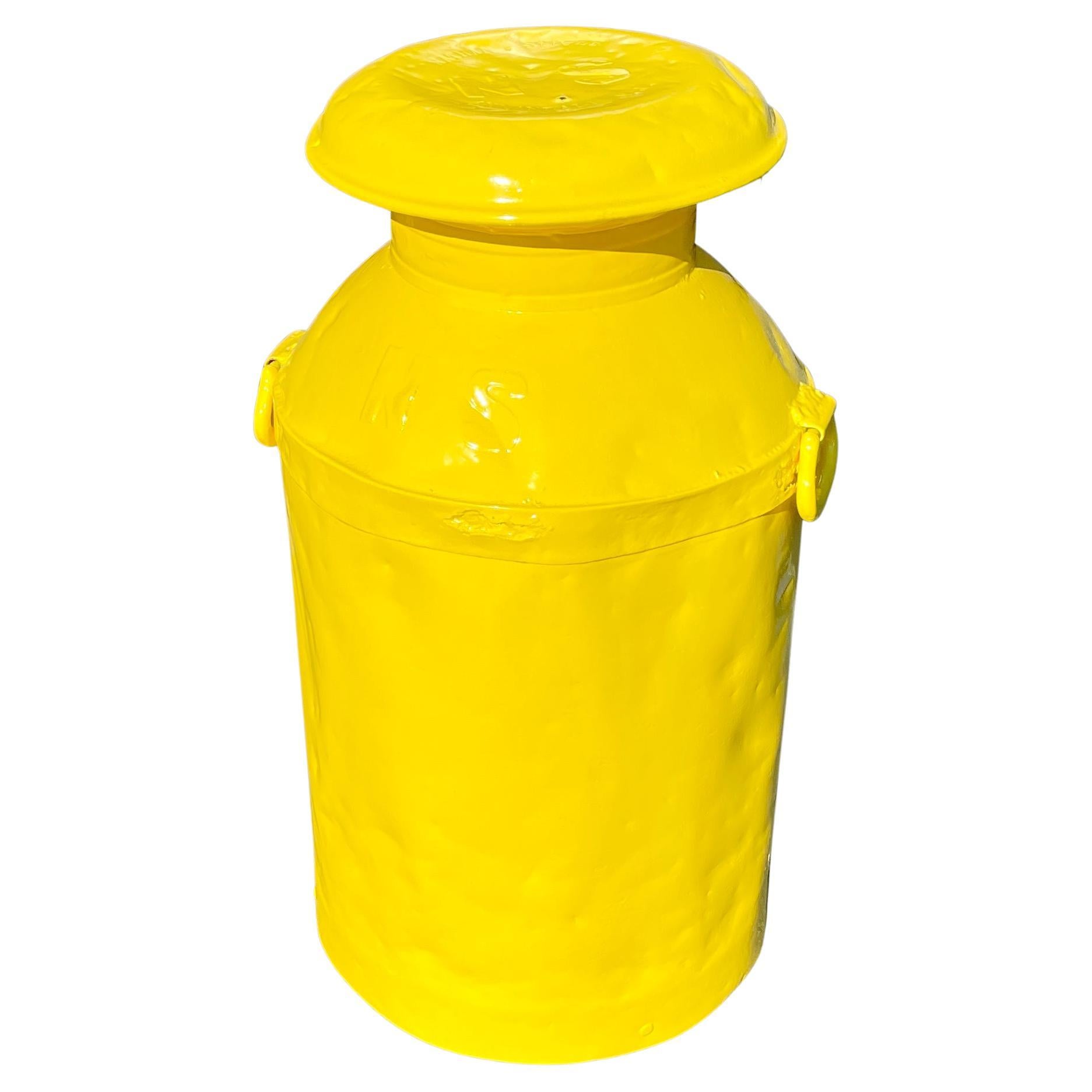 Vintage metal milk can table, early 20th century. This heavy gauge metal milk jug has been updated with an exciting bright sunshine yellow powder coat finish. The can is sturdy and will make a striking addition as a side table to any room or decor.