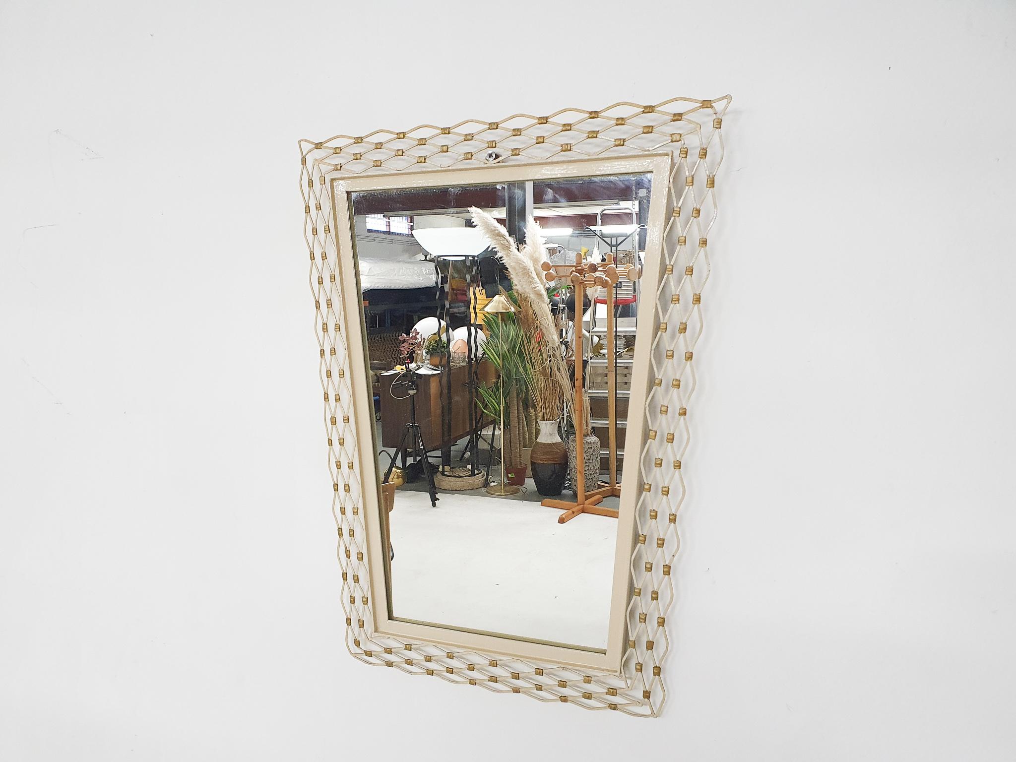 White and gold metal mirror.
The glass of the mirror has a chip missing, but it is only visible in the back.