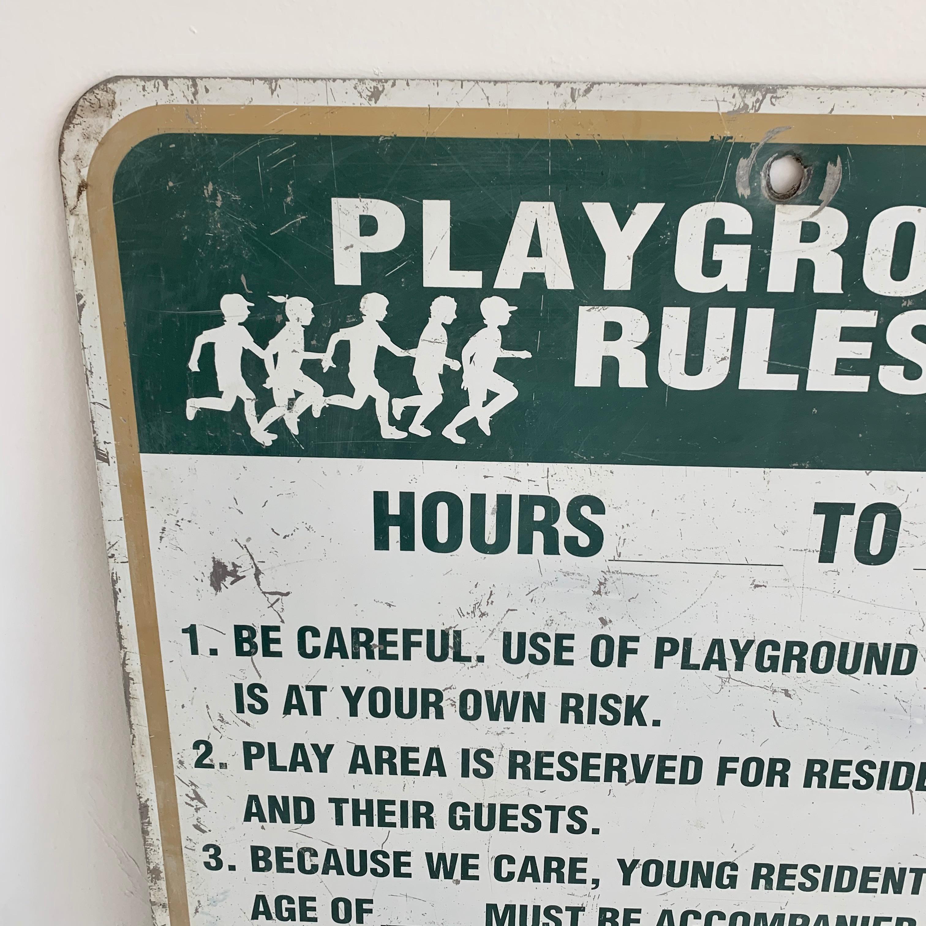 Fun metal sign from a California playground. 7 standard rules for the play area written. Used sign but the playground hours were never marked. Fun piece for a home playground or playroom. Worn condition.