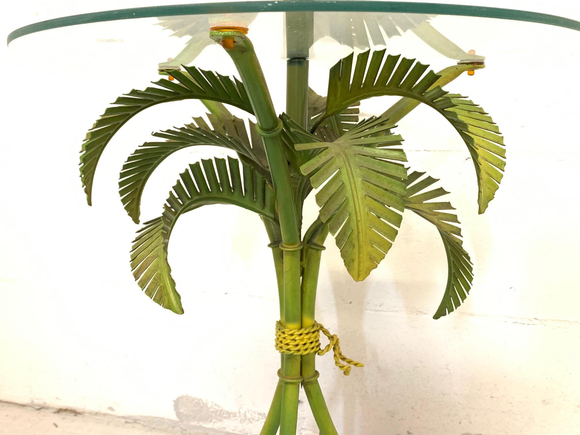 Vintage floor lamp features sculptural tole metal palm tree fronds and a round glass shelf. Good vintage condition with minor imperfections consistent with age.