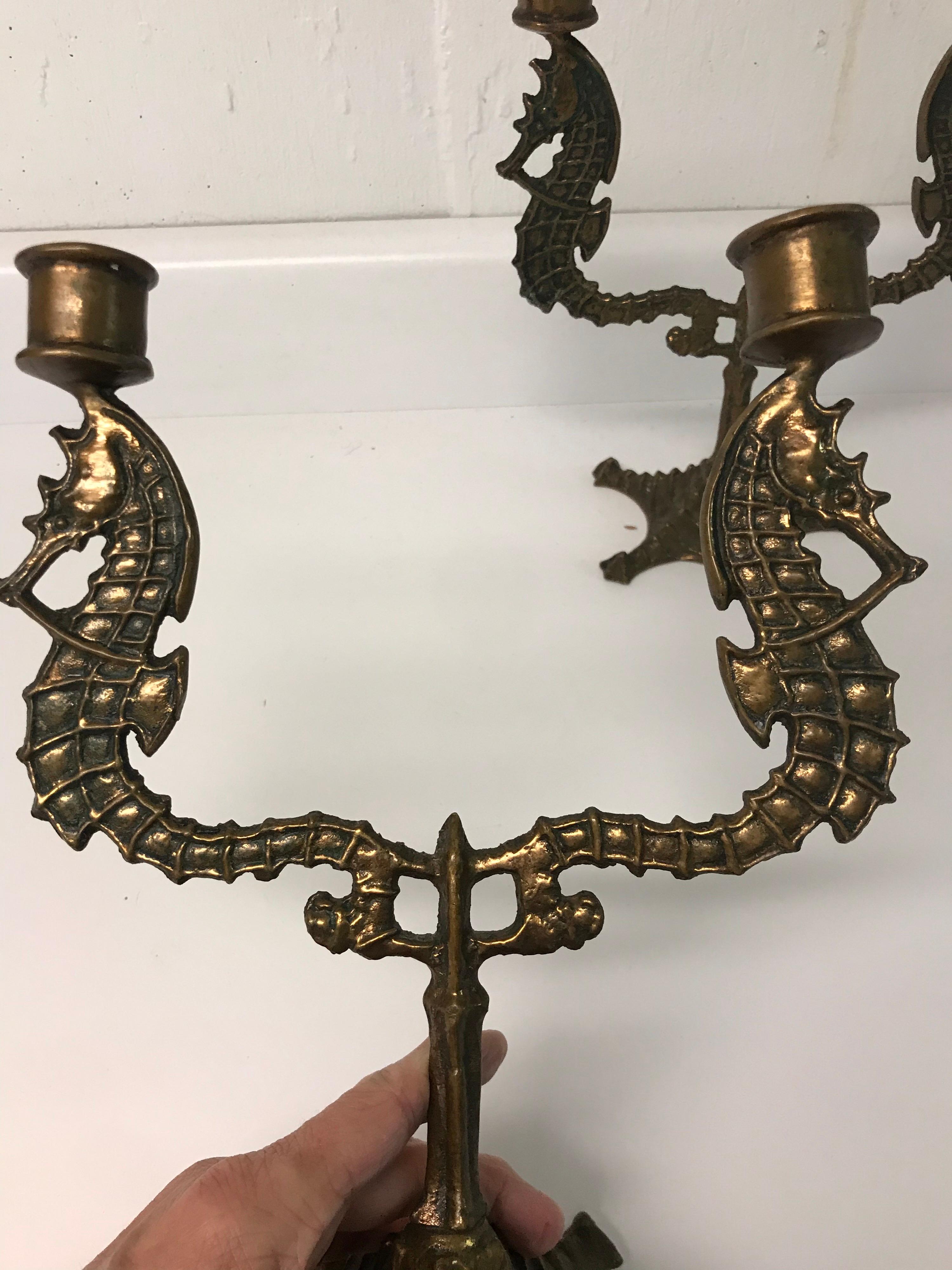 This is a pair of heavy metal bronze copper candlesticks. The sea motif of seahorse and starfish is unusual but perfect for a seaside home.
They are marked on the bottom but I was unable to make out the name of maker.