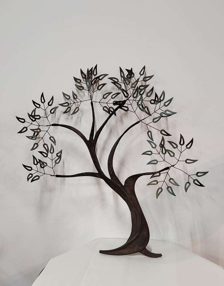 1960s vintage twisted metal tree of life wall art sculpture 

Twisted metal tree design with extended branches to brass patina metal leaves.

This decorative metal tree of life wall sculpture sits two and one forth inches away from the
