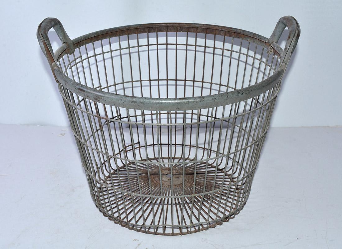 Vintage metal wire basket with two handles intended for claming. Now the perfect size for storing blankets, throws and other home accents, toys or a planter - the vintage metal basket has molded handles for carrying convenience and are a great match