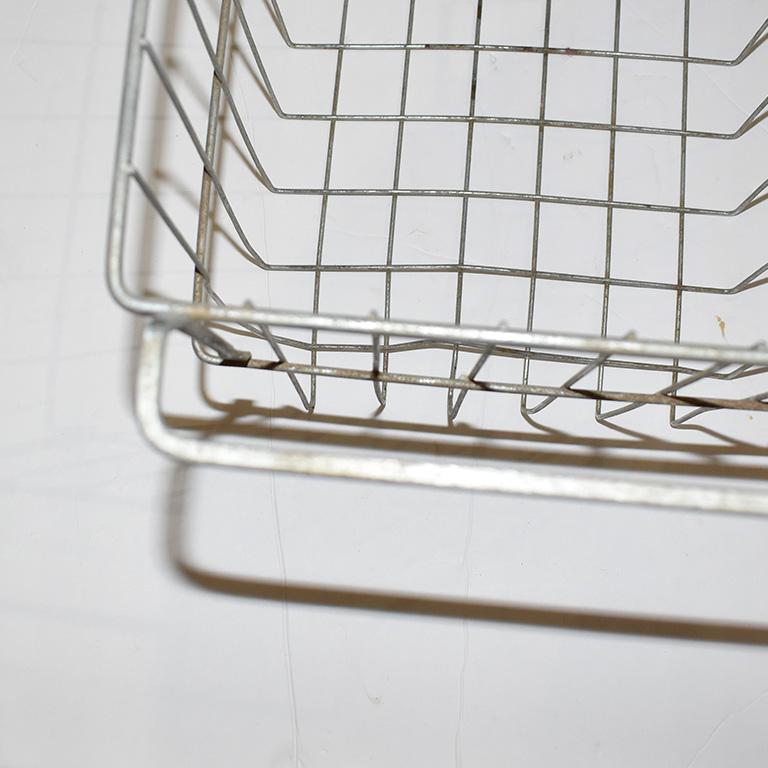 Vintage metal wire locker basket with handles. This would make a great piece to store items on a coffee table to add height, or even for magazines or small blankets.