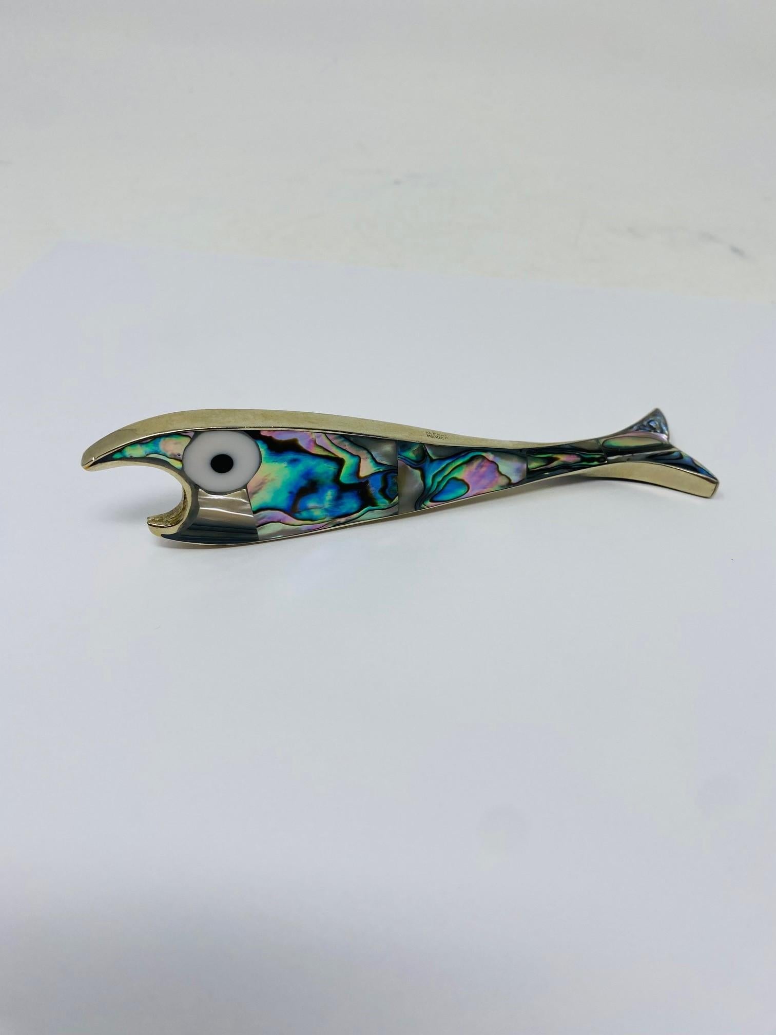 Mexican Alpaca Silver and Abalone Bottle Opener.  A beautiful statement piece at the bar, especially one with Mid-century influences. The Abalone and silver are extraordinary and a great addition to your bar and décor. Details that interpret your