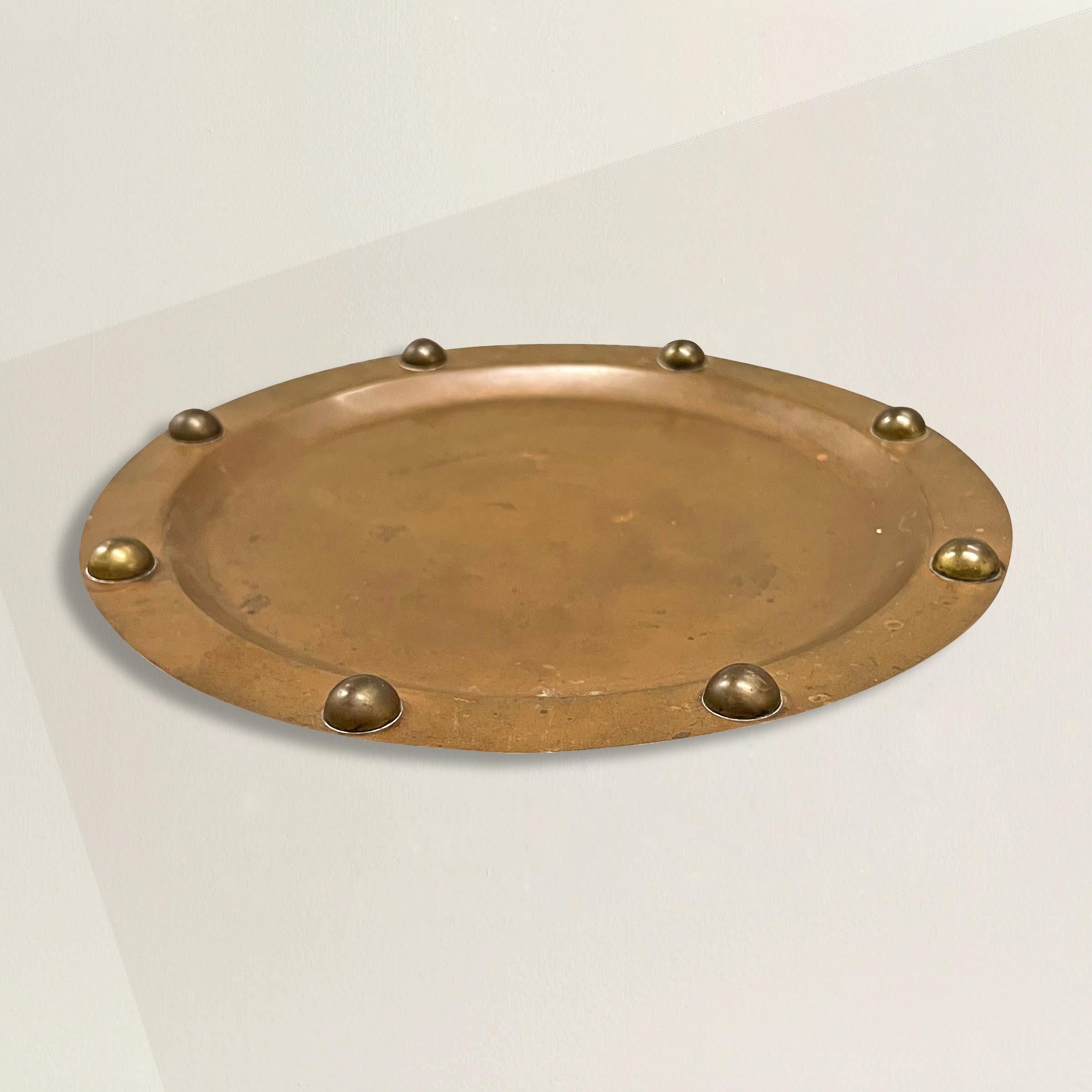 A chic mid-20th century Mexican copper tray with robust round brass rivets around the perimeter. The perfect tray to set on your bar to hold decanters or glasses, or on your entry console table to hold mail, keys, or pocket change.