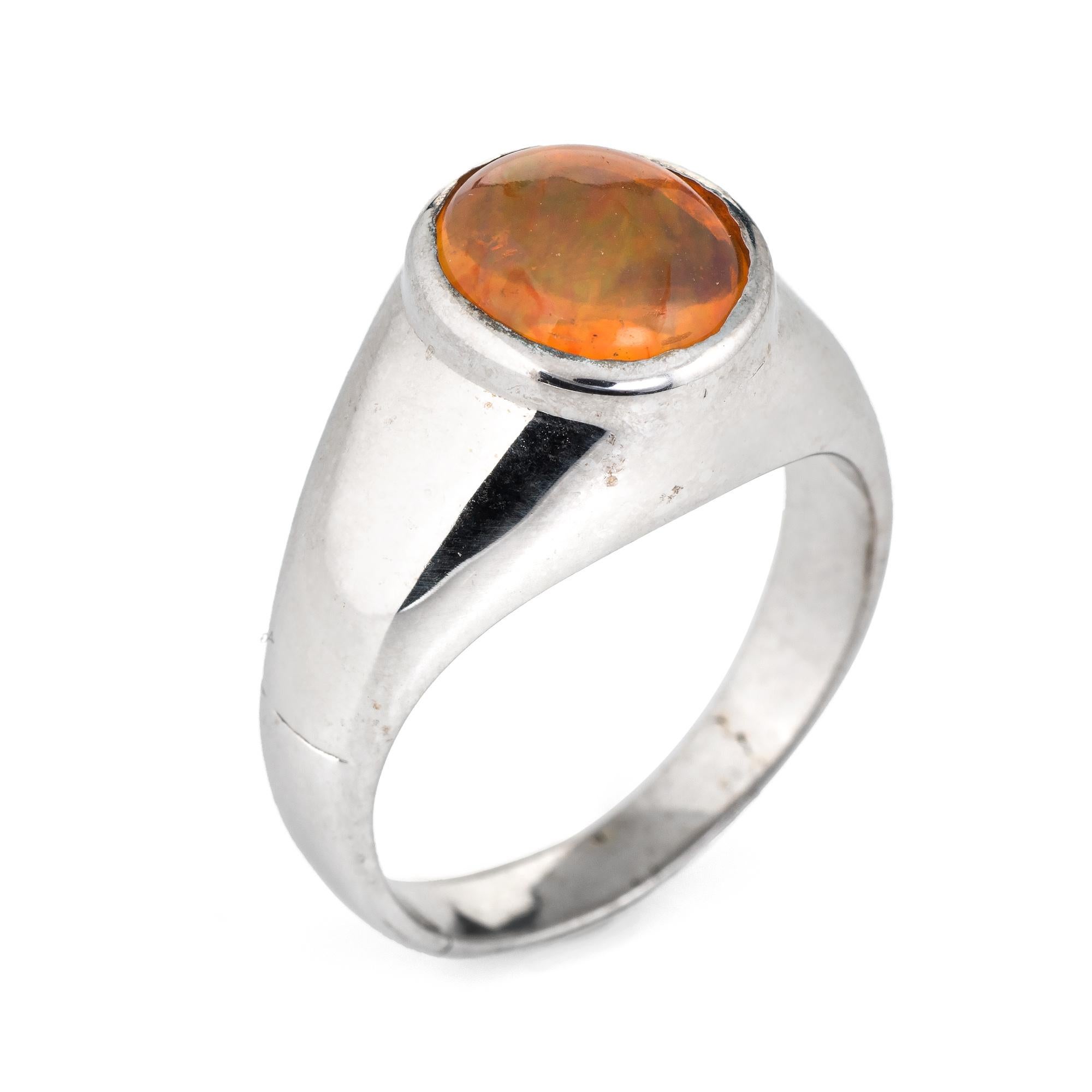 Elegant estate Mexican fire opal ring crafted in 14 karat white gold. 

Cabochon cut natural opal measures 9.5mm (estimated at 4 carats). The opal is in excellent condition and free of cracks or chips. 

The natural opal shows a nice play of colors