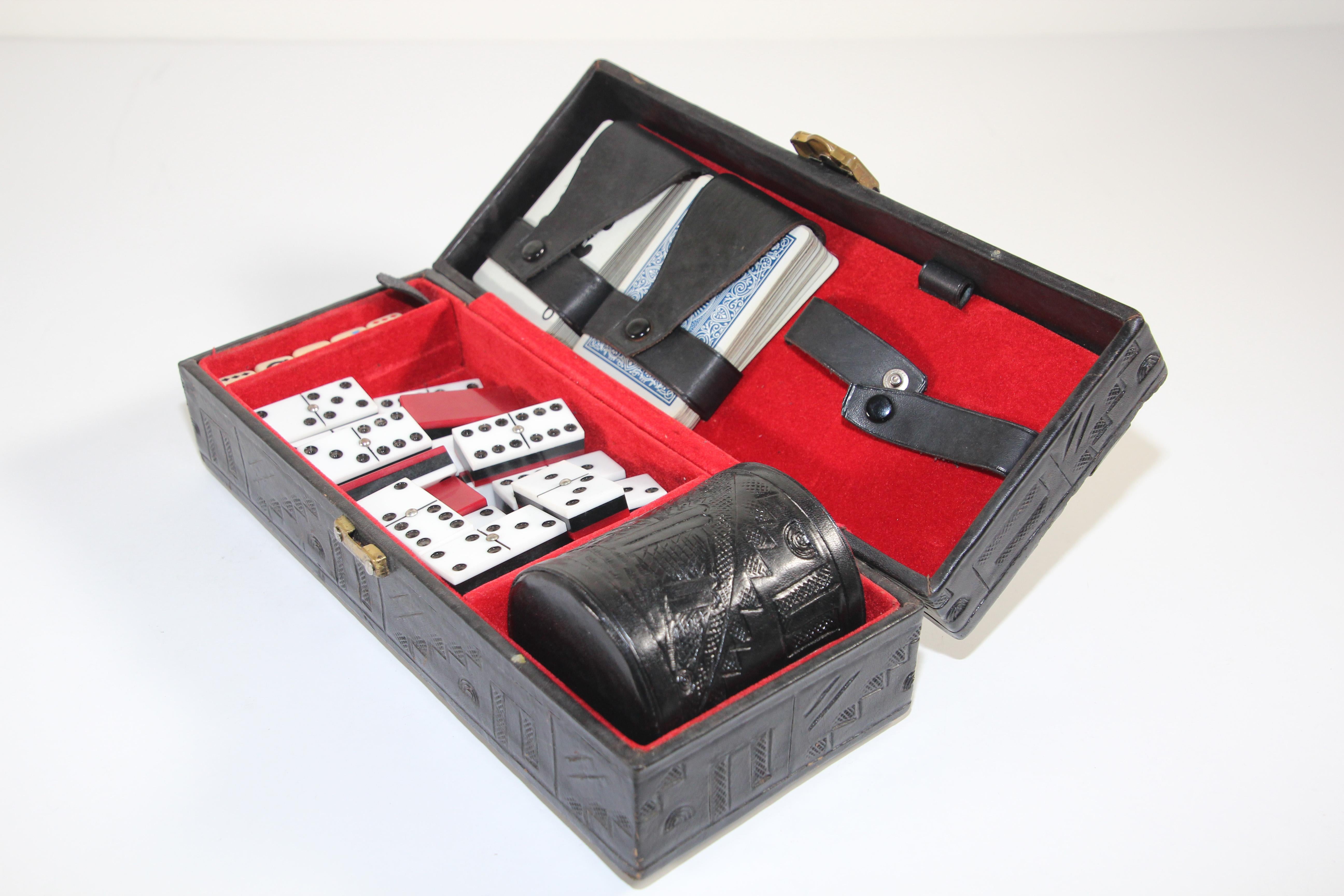 Mexican hand tooled embossed leather case with leather cup. 5- Four sided Dice. 2-Decks of cards.
28 black, red and white dominoes with metal pin in center to avoid scratches when playing or shuffling. Dominoes.
Mexican tooled leather case 