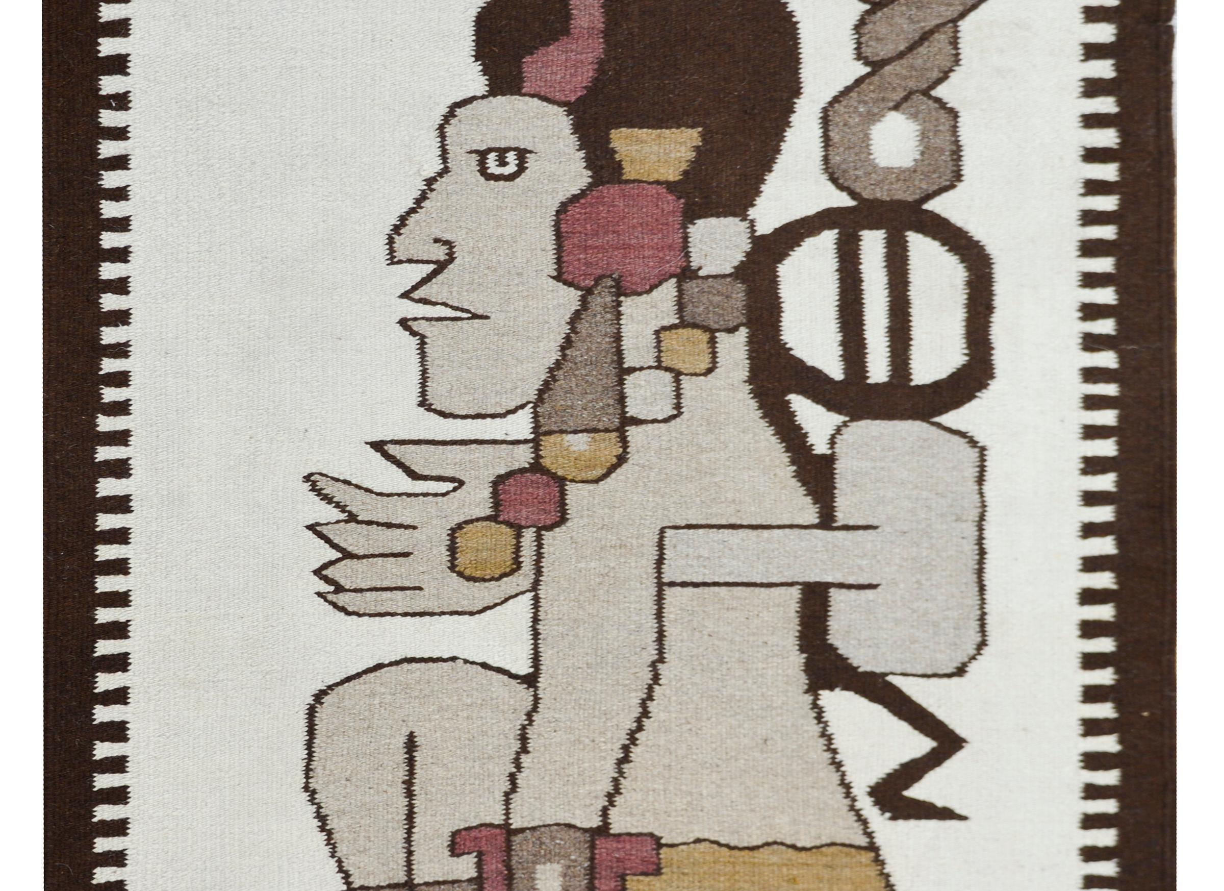 A wonderful late-20th century Mexican hand-woven wool rug with a large central Aztec figure in profile, and surrounded by a brown wool border with two stripes at each end.